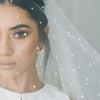 A bride wearing pearl wedding veil by Madame Tulle Bridal