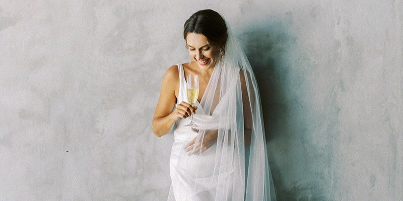 Model wears a one tier soft tulle wedding veil