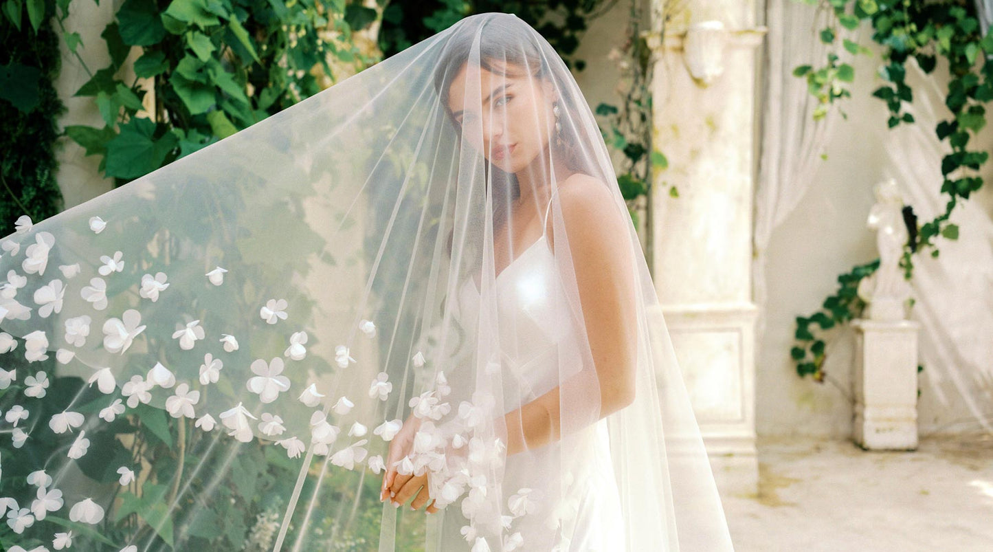 A bride wearing a wedding veil with flowers over her face