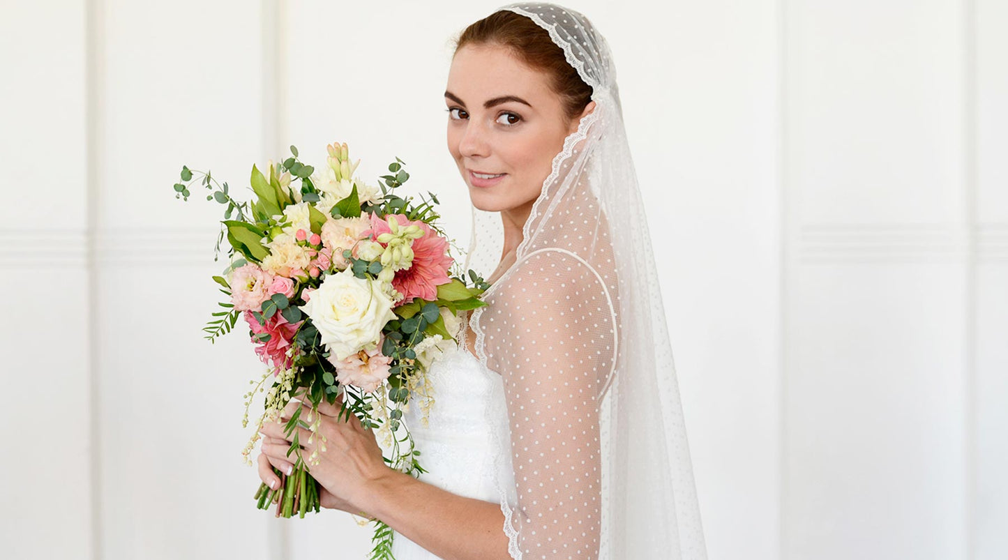 A bride wearing a polka dot wedding veil