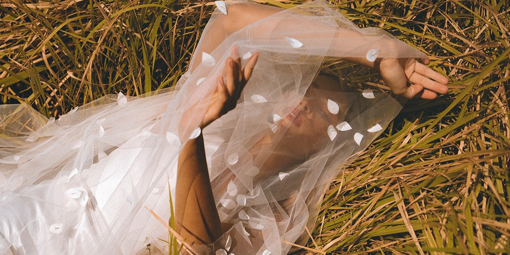 Model wears a one tier fabric floral wedding veil