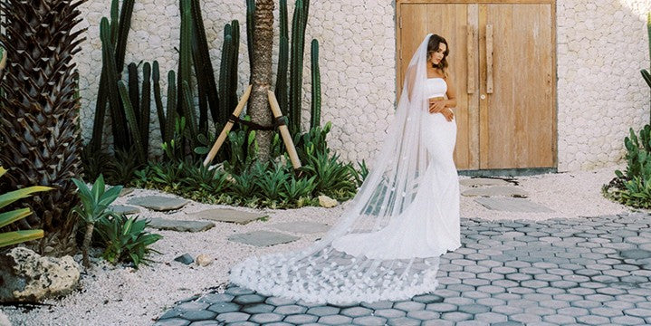 model wears a long cathedral floral wedding veil