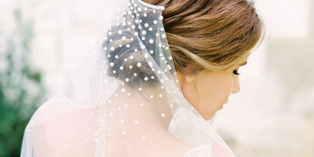model wears a mantilla pearl wedding veil