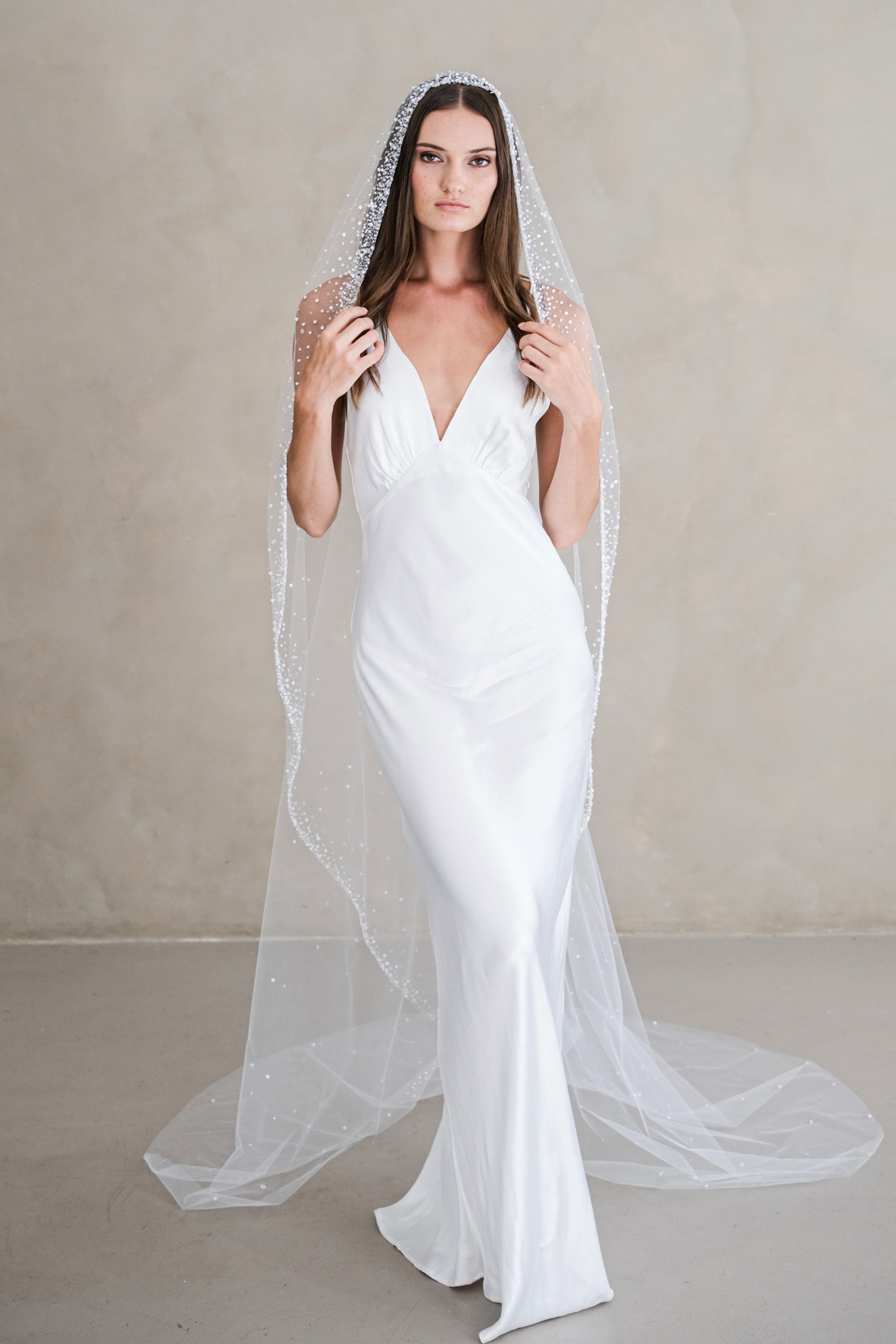 Model wears a mantilla wedding veil, one tier veil with beads and sequins.