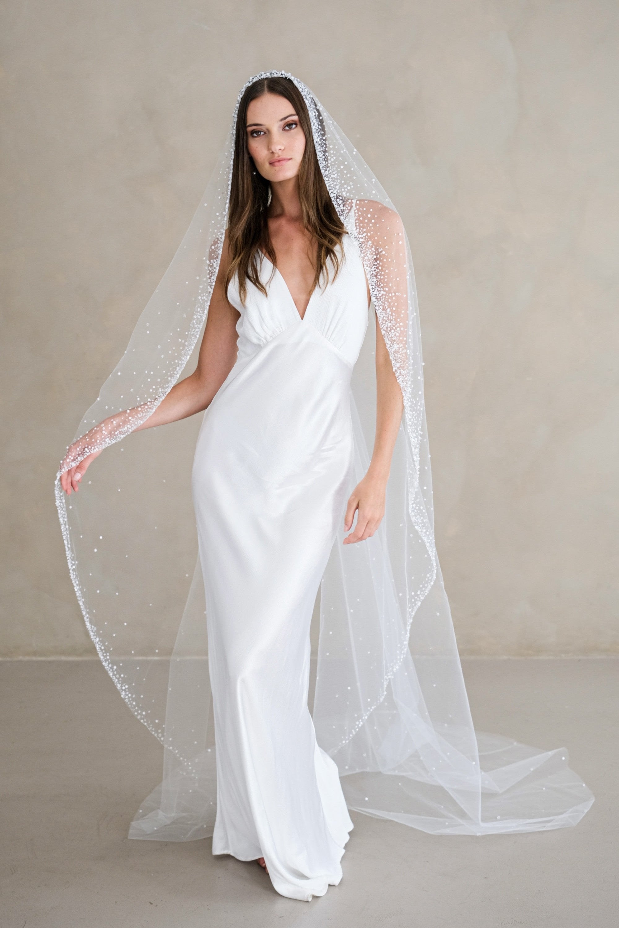 Model wears a mantilla wedding veil, one tier veil with beads and sequins.