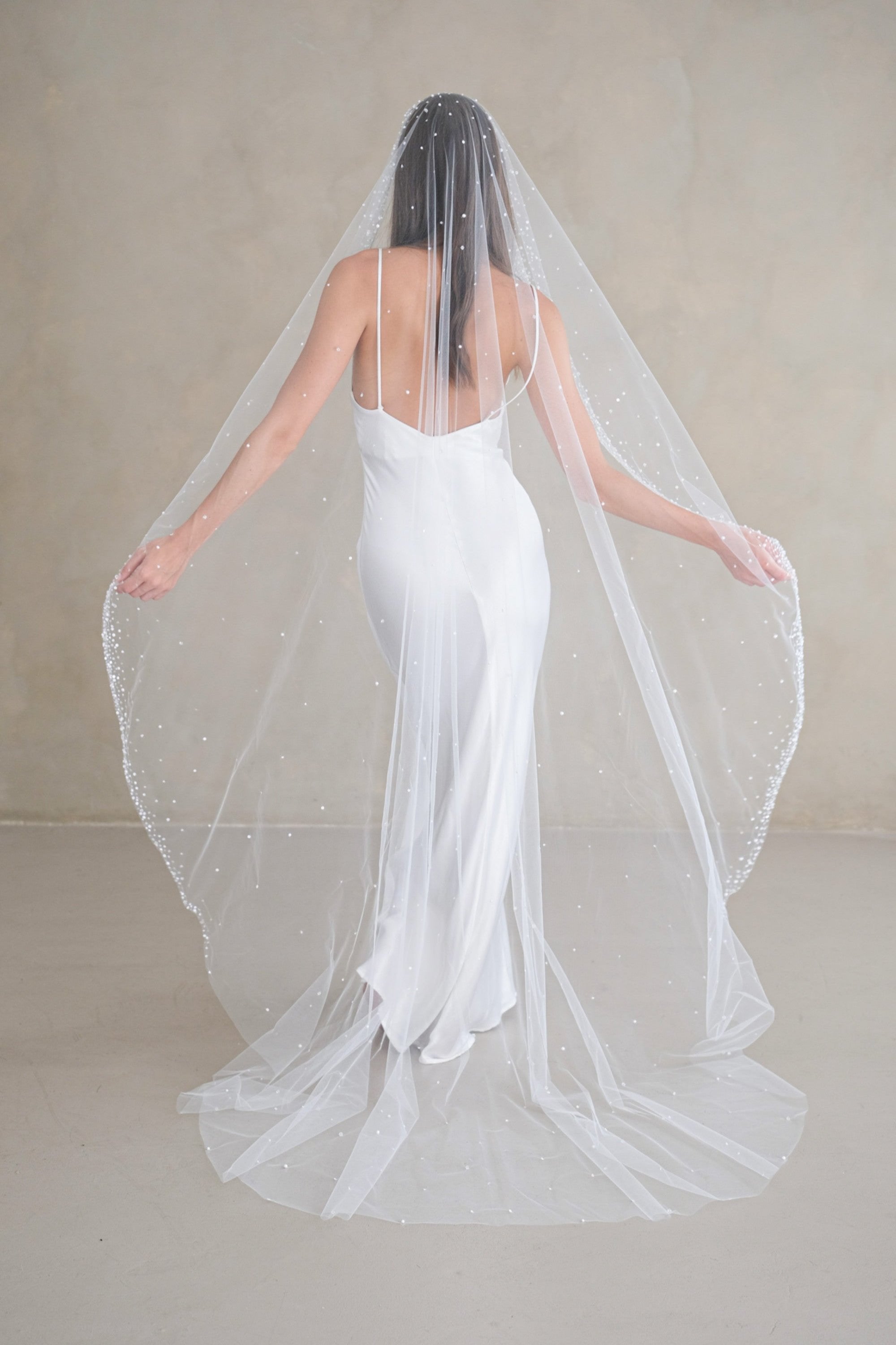 Model wears a mantilla wedding veil, one tier veil with beads and sequins.