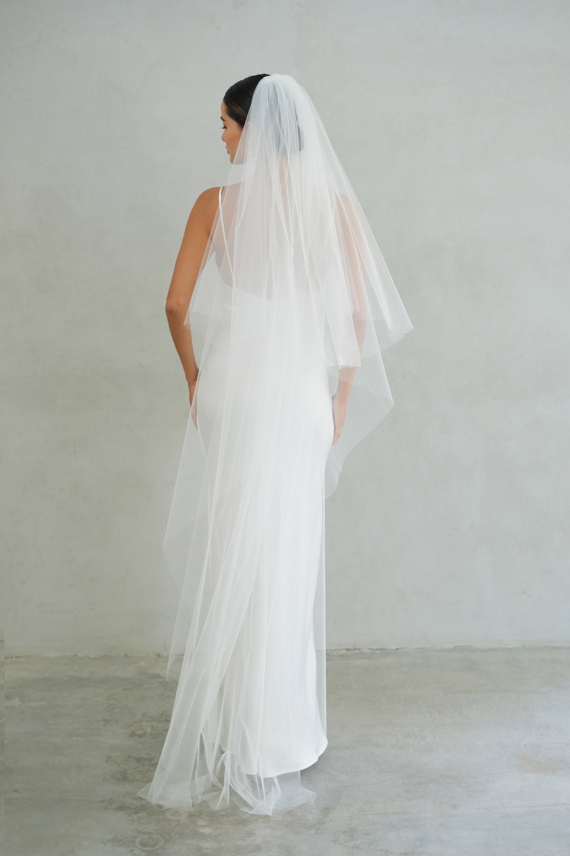 A model wearing the Alexa II two tier plain wedding veil by Madame Tulle bridal Sydney