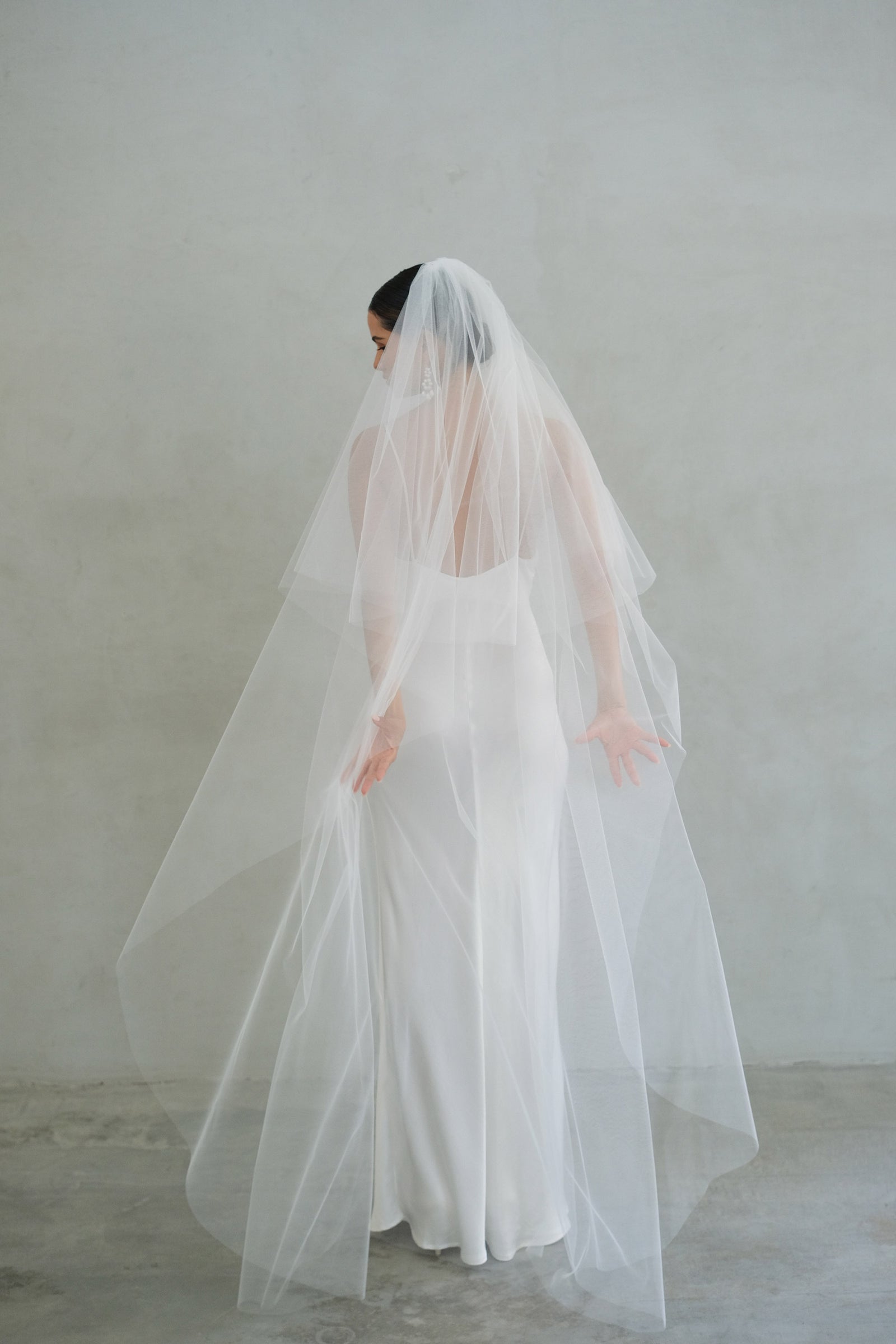 A model wearing the Alexa II two tier plain wedding veil by Madame Tulle bridal Sydney