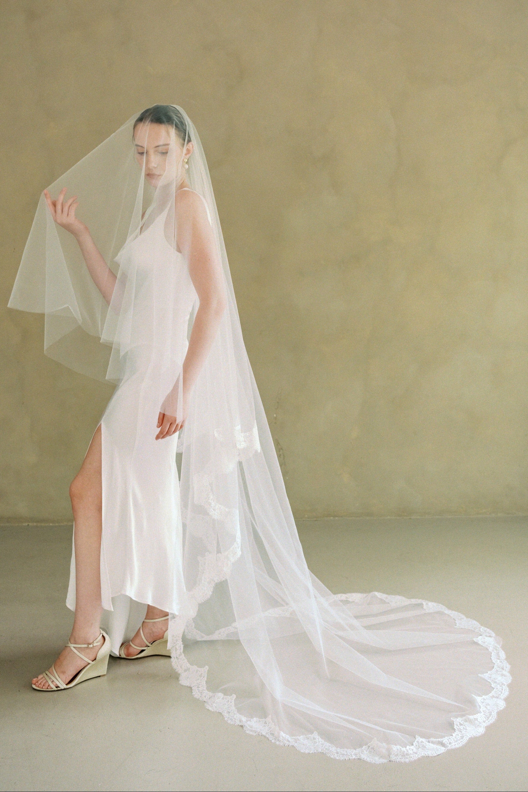 model wears a drop veil with partial lace trim