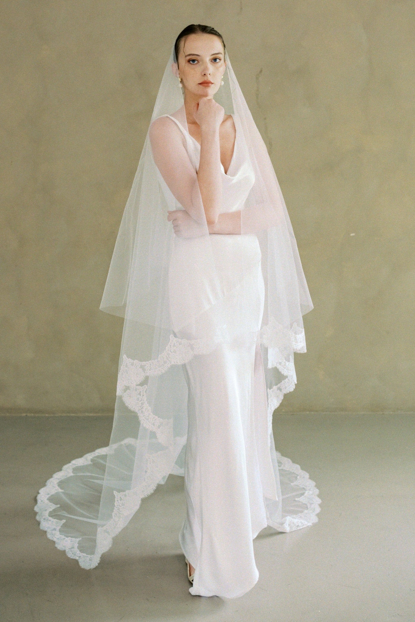 model wears a drop veil with partial lace trim