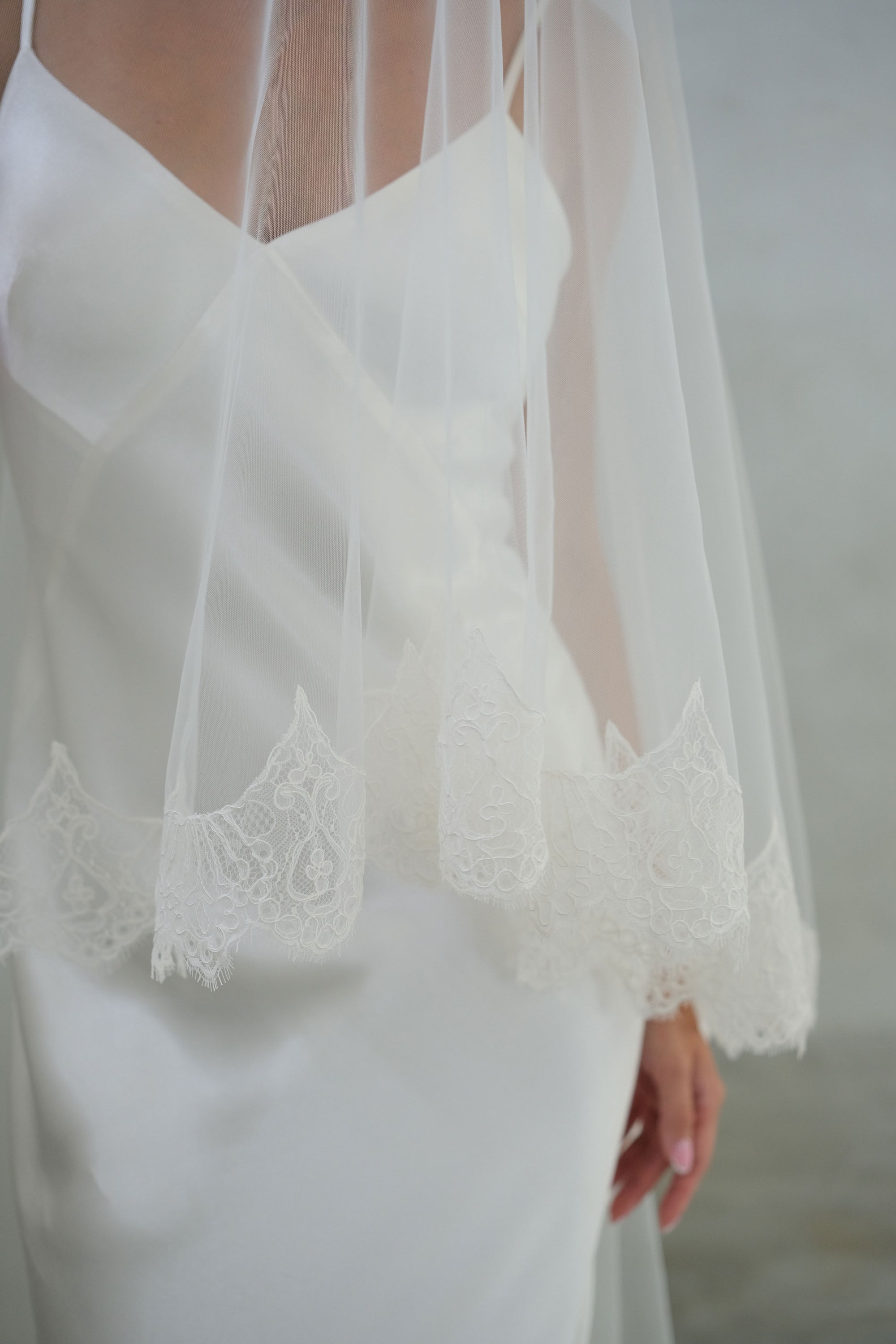 Close up of delicate lace trim on ivory colour bridal veil blusher