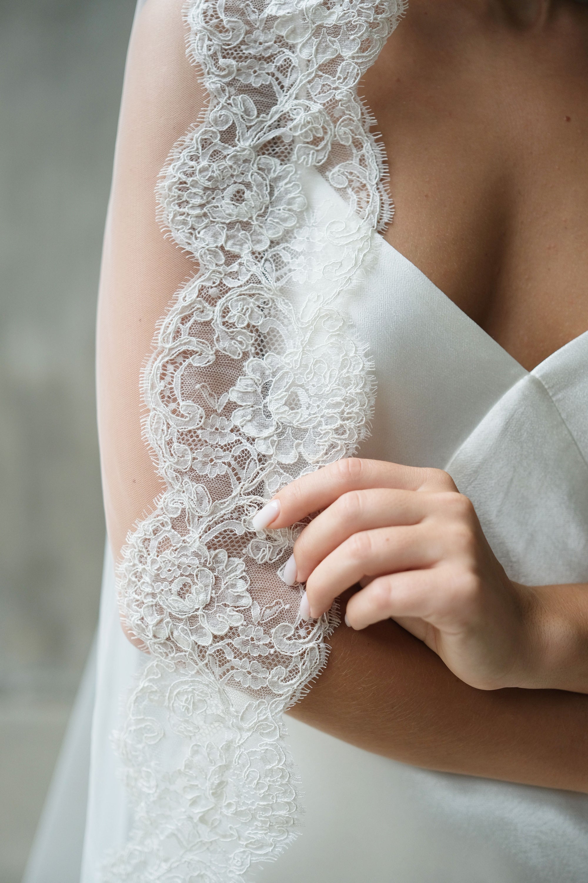 Close-up showing detail of corded floral lace trim on mantilla bridal veil