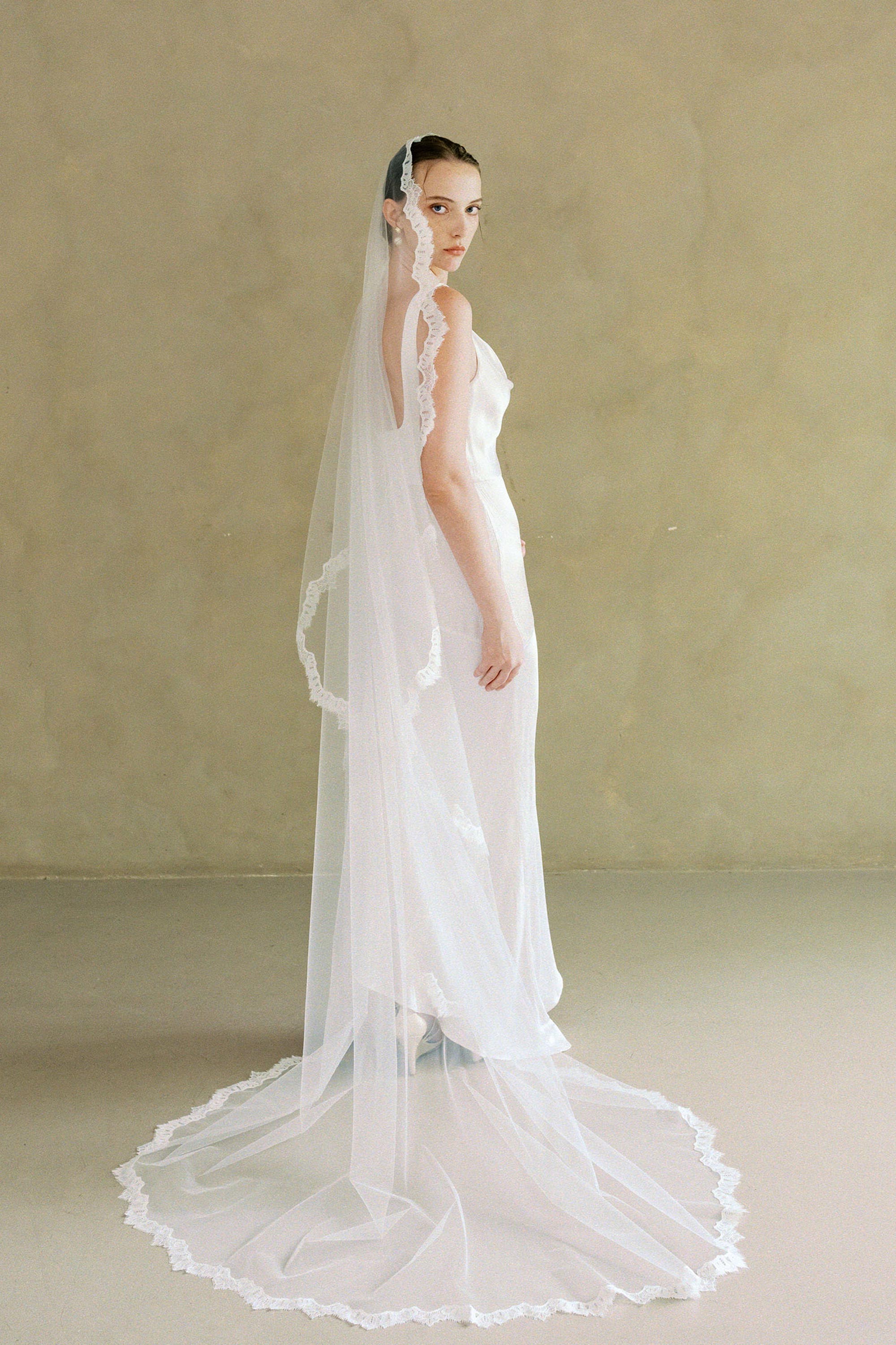 model wears one-tier lace Mantilla veil lace trim wedding veil