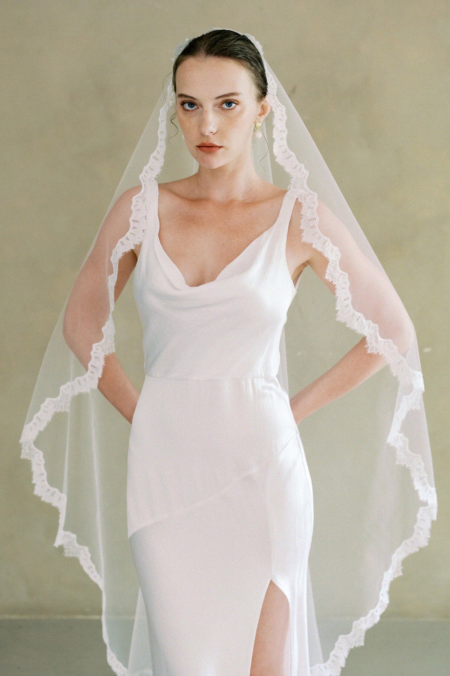 Model wears one-tier lace Mantilla wedding veil with simple lace trim 