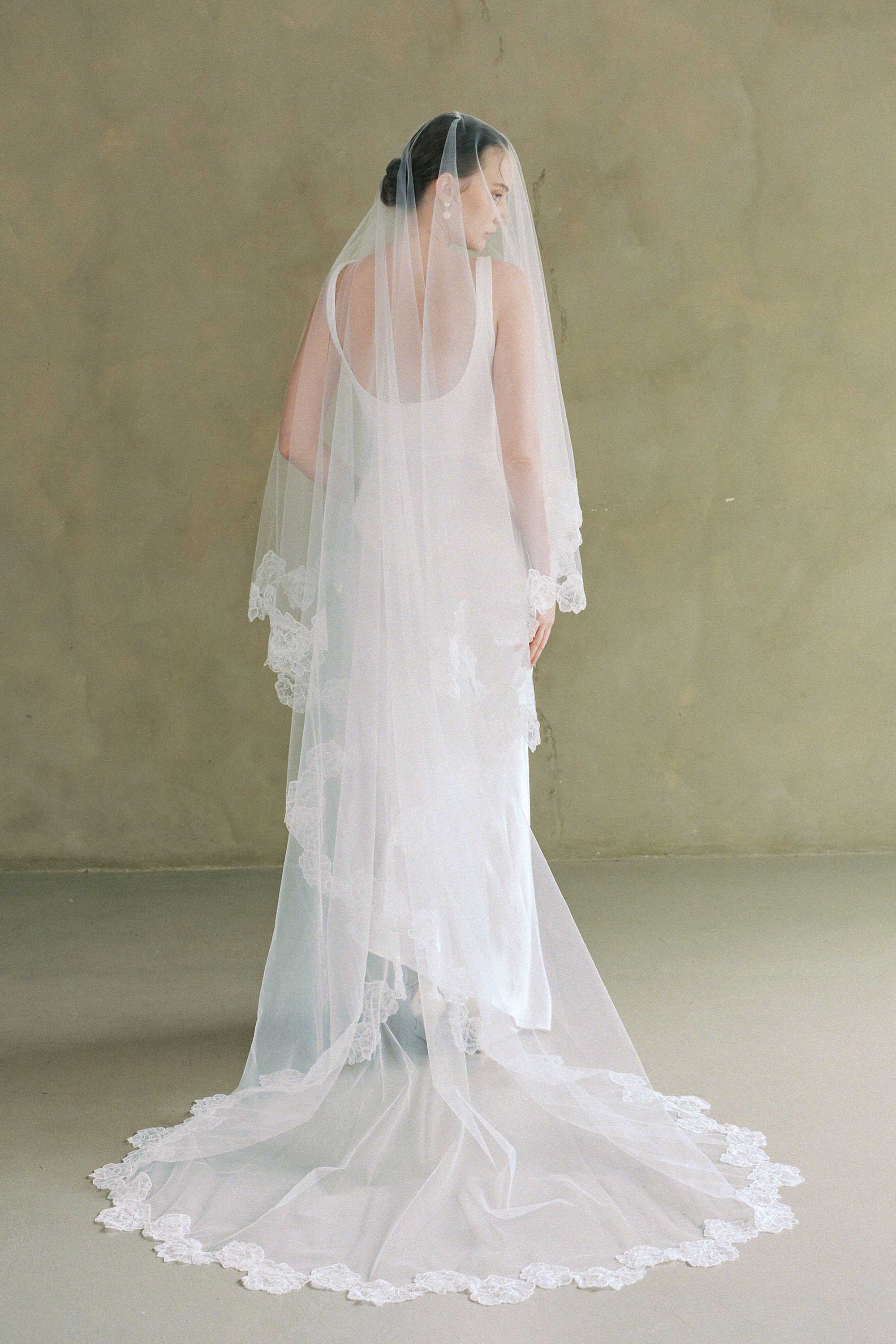 model wears two-tier lace trim veil, drop wedding veil