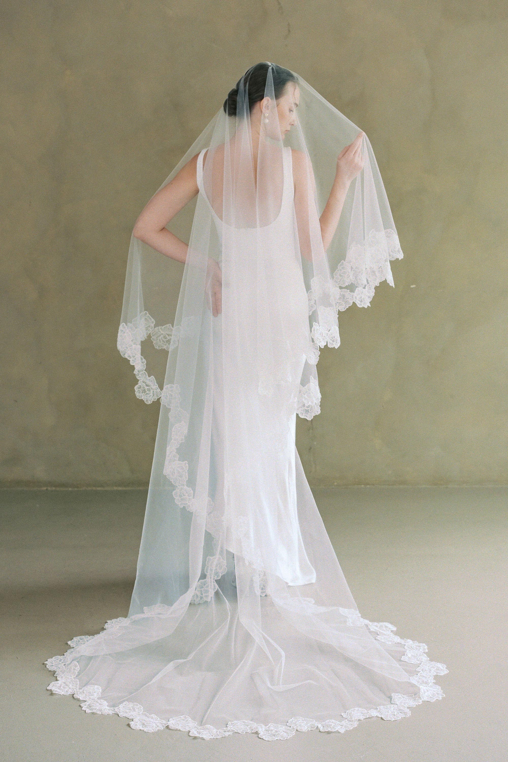 model wears two-tier lace trim wedding veil