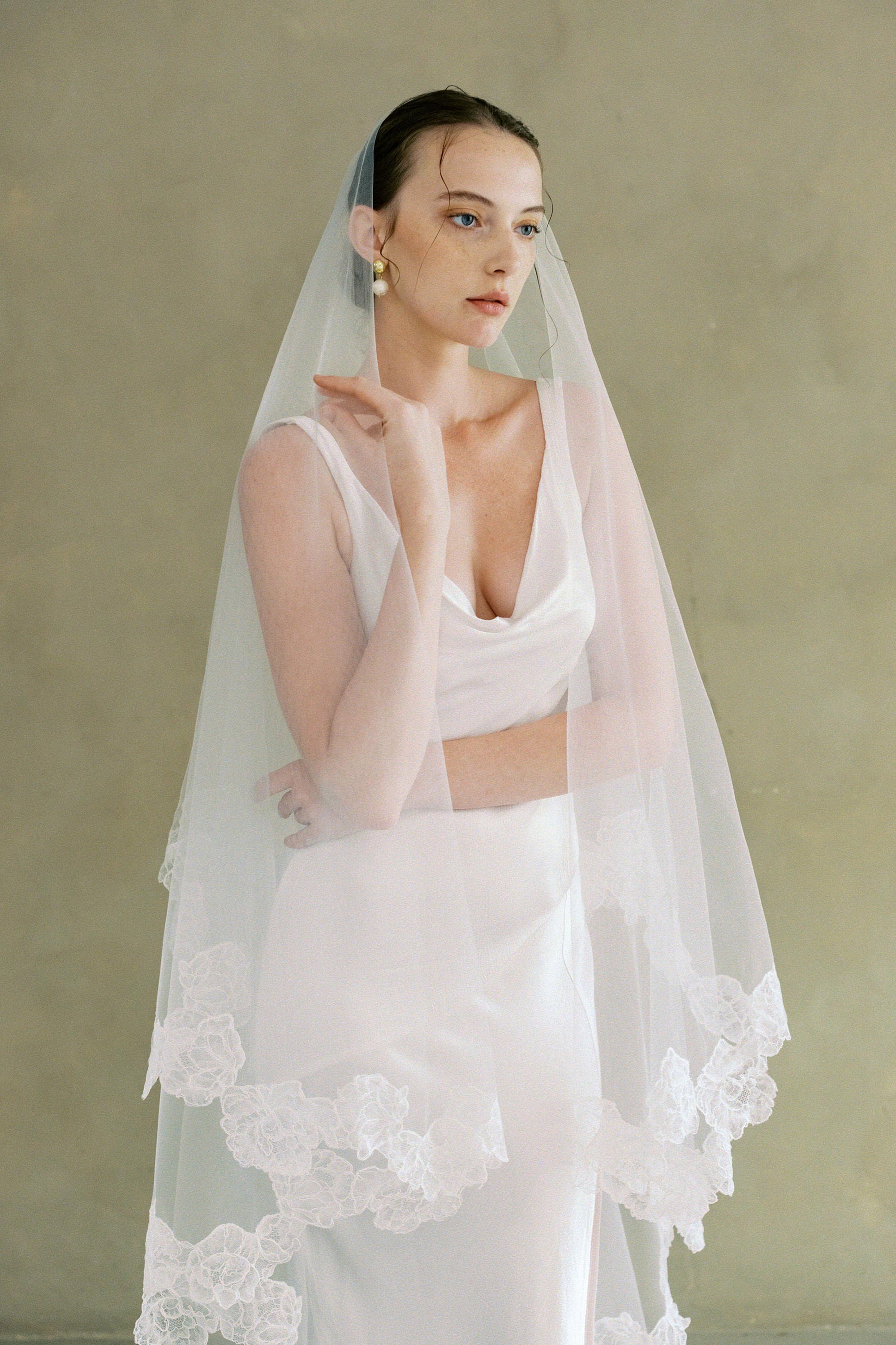 model wears two-tier lace trim veil, drop wedding veil