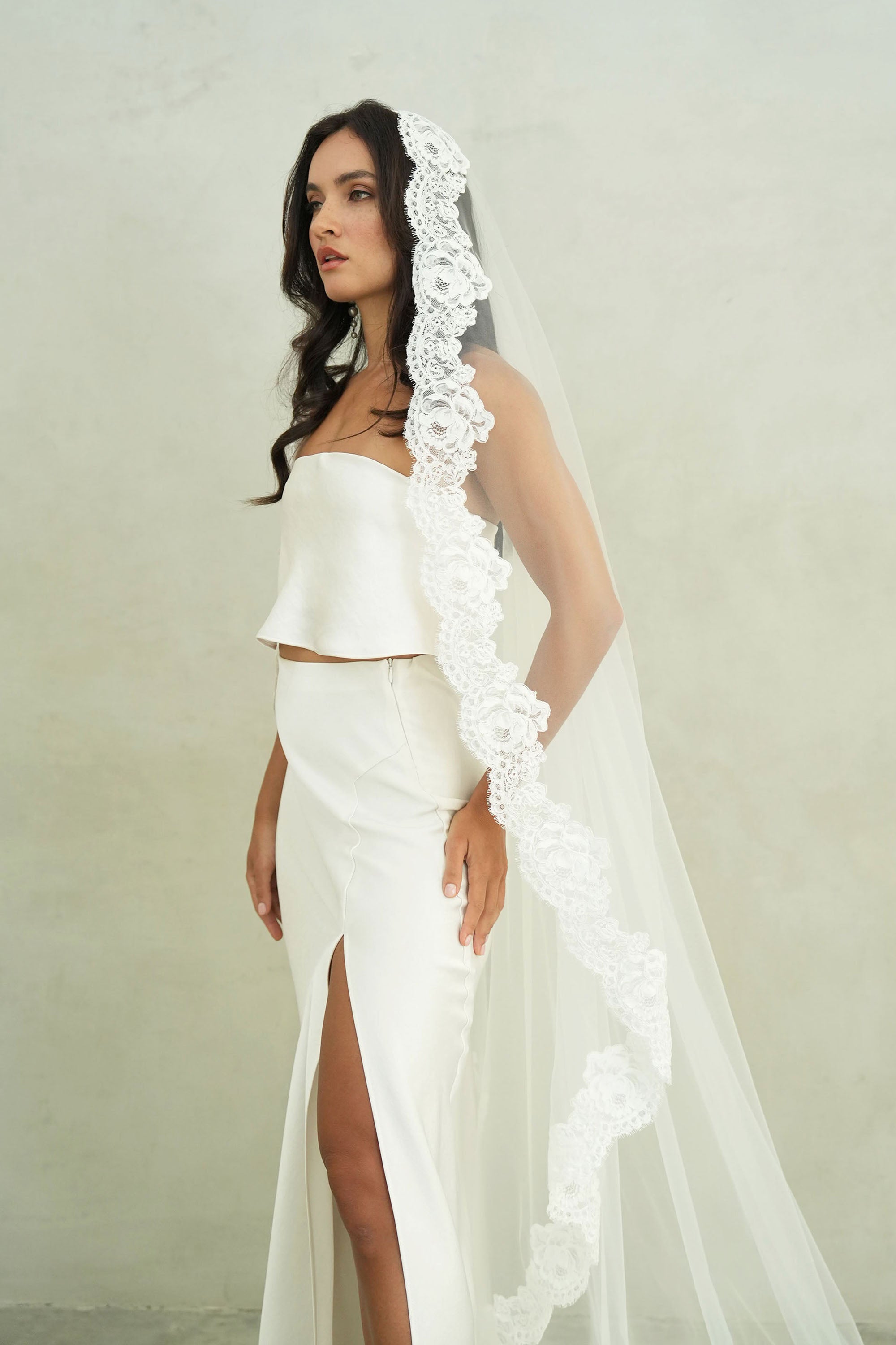 model wears mantilla veil, one-tier lace trim wedding veil