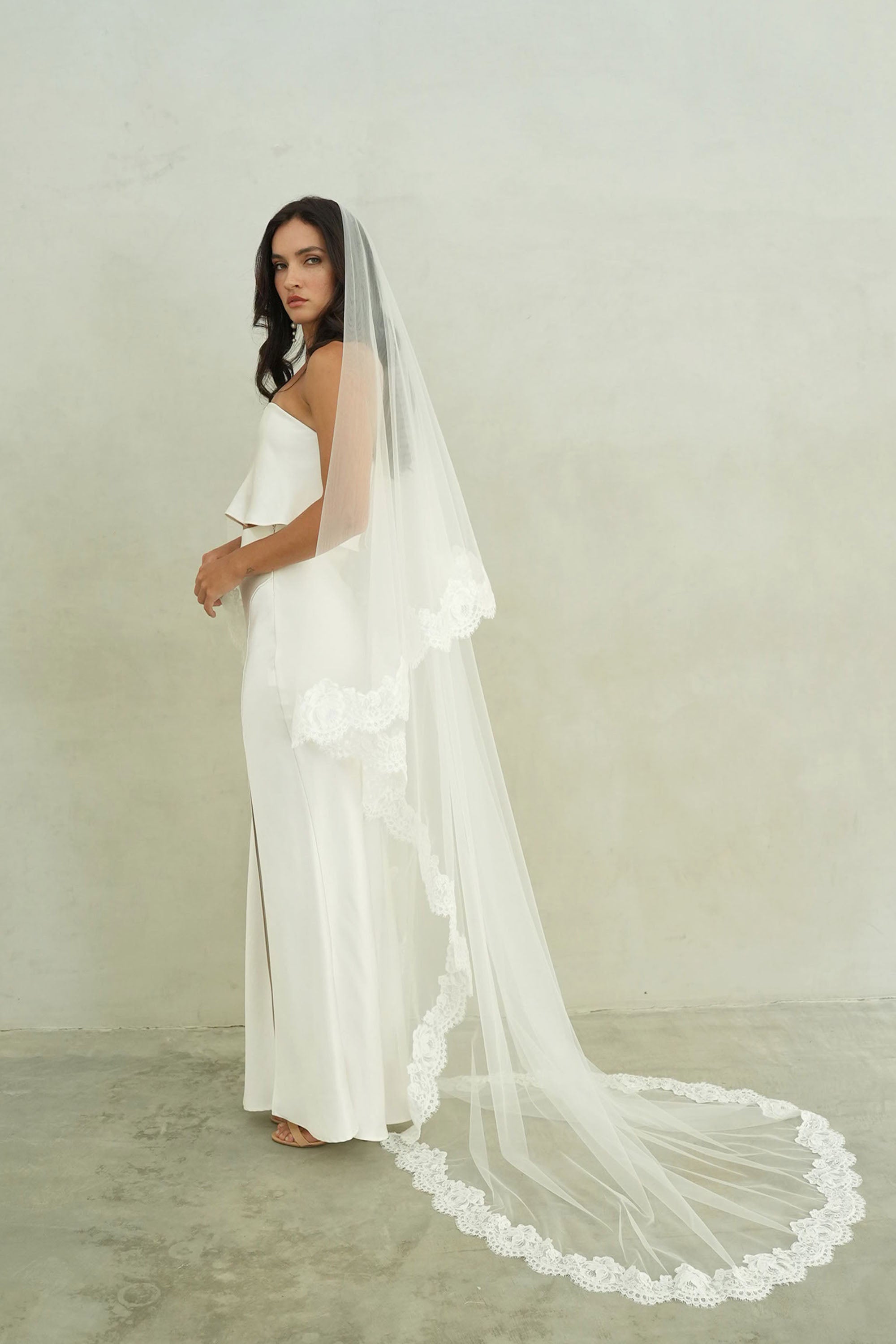 model wears mantilla veil, drop lace trim wedding veil