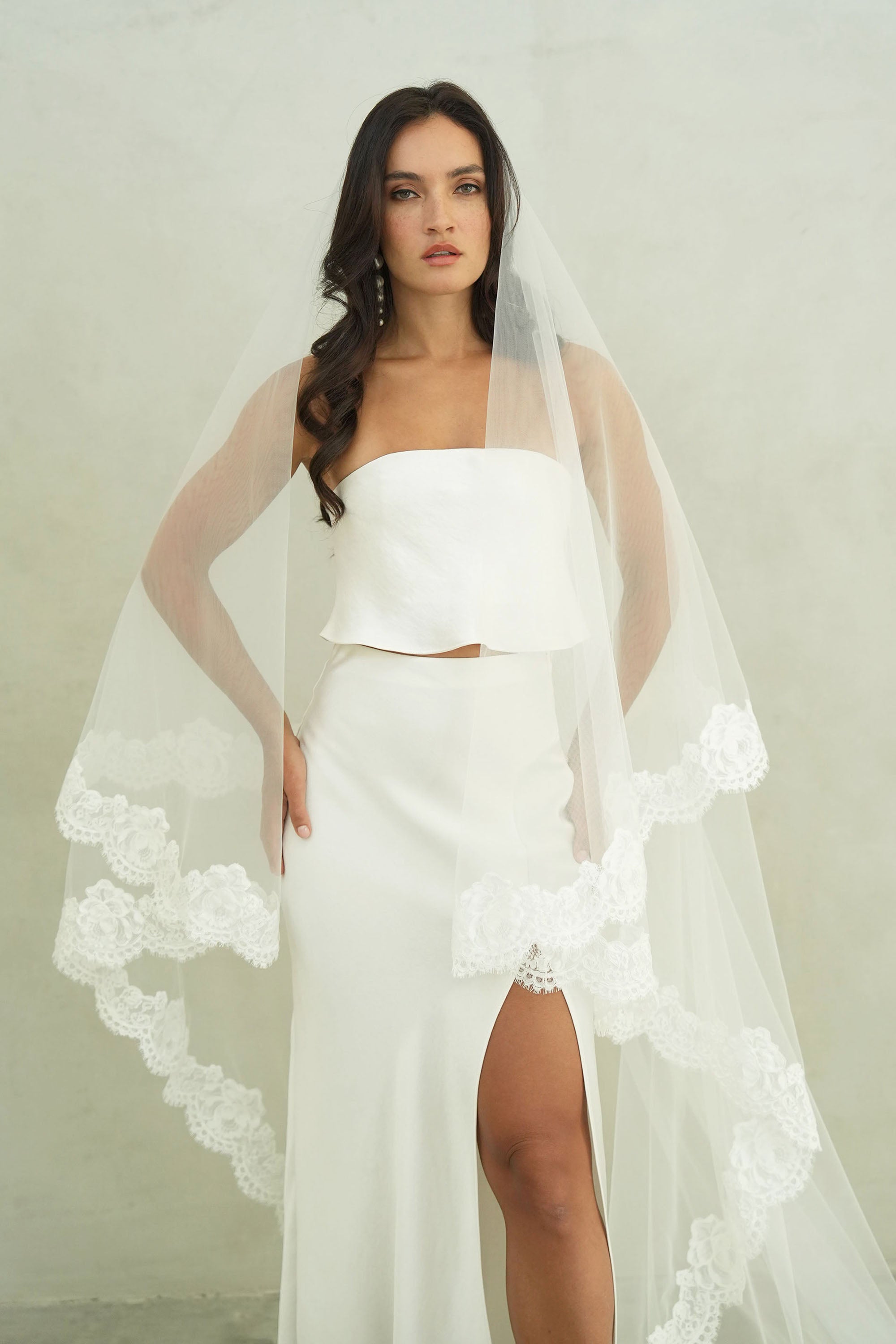 model wears mantilla veil, drop lace trim wedding veil