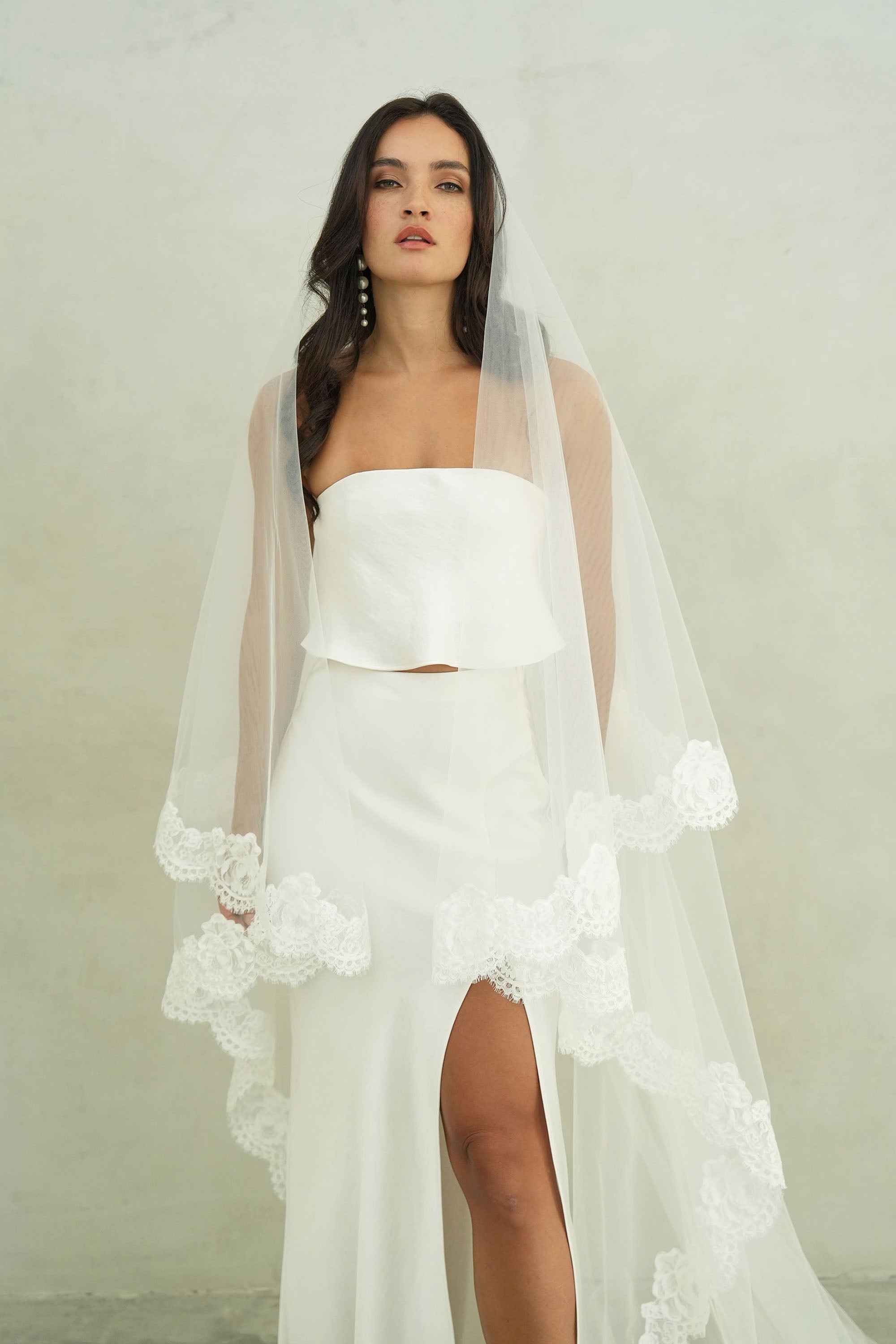 model wears mantilla veil, drop lace trim wedding veil