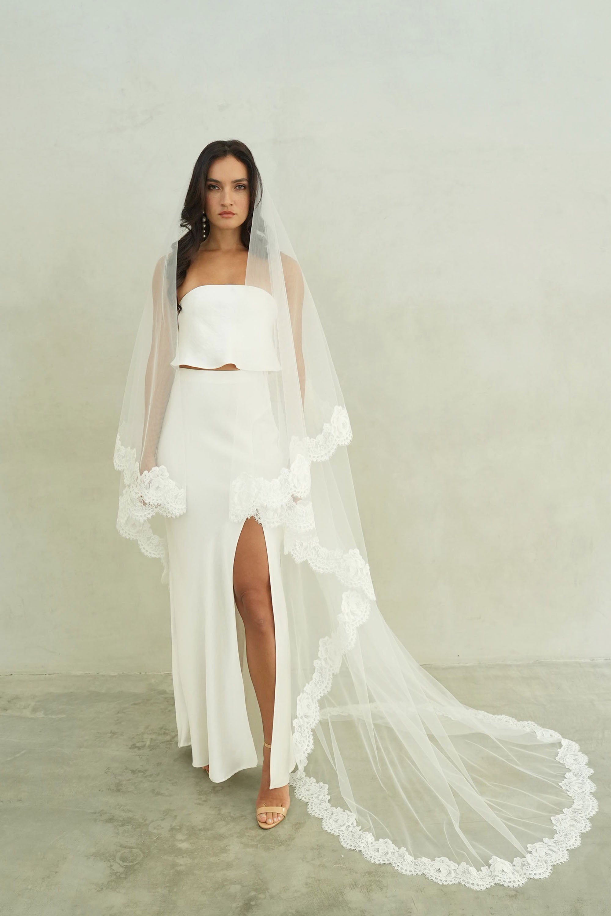 model wears mantilla veil, drop lace trim wedding veil