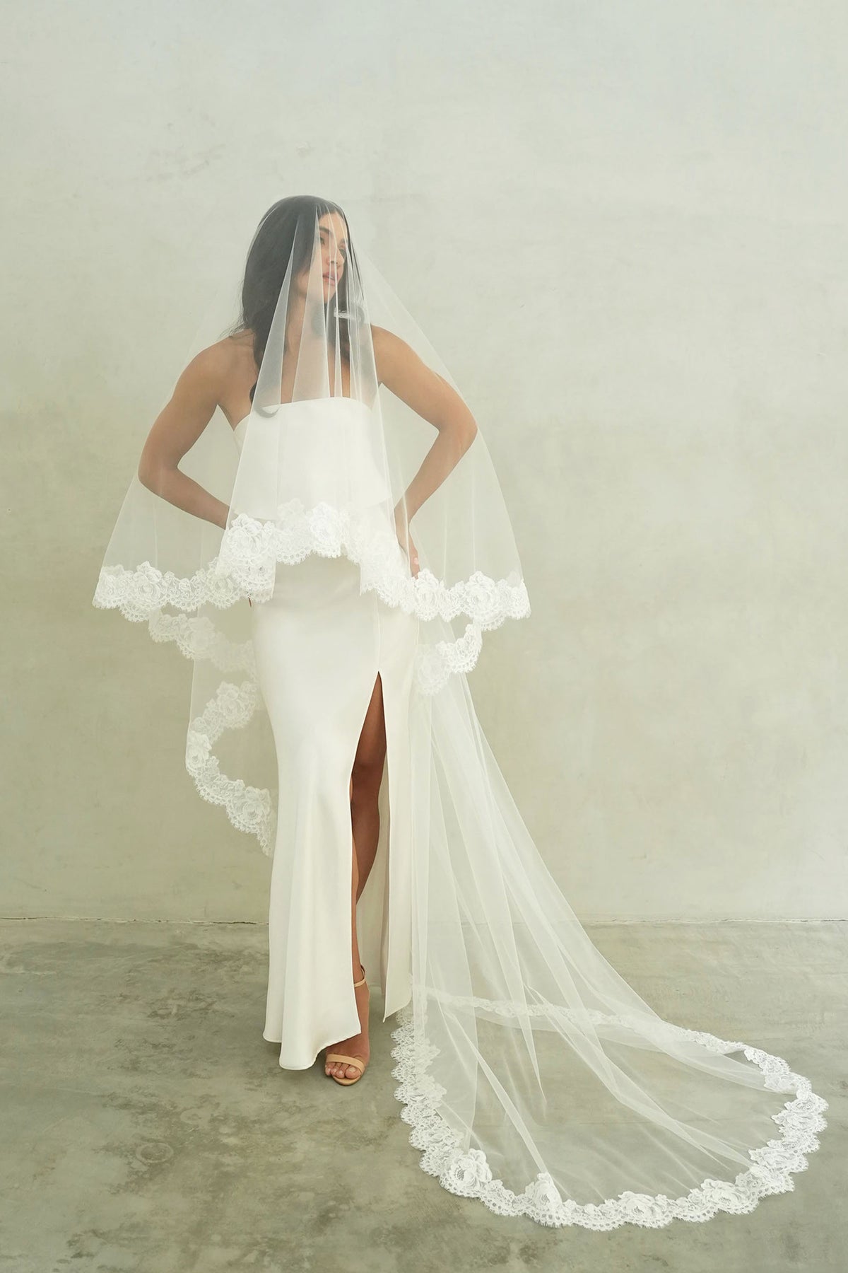 model wears mantilla veil, drop lace trim wedding veil