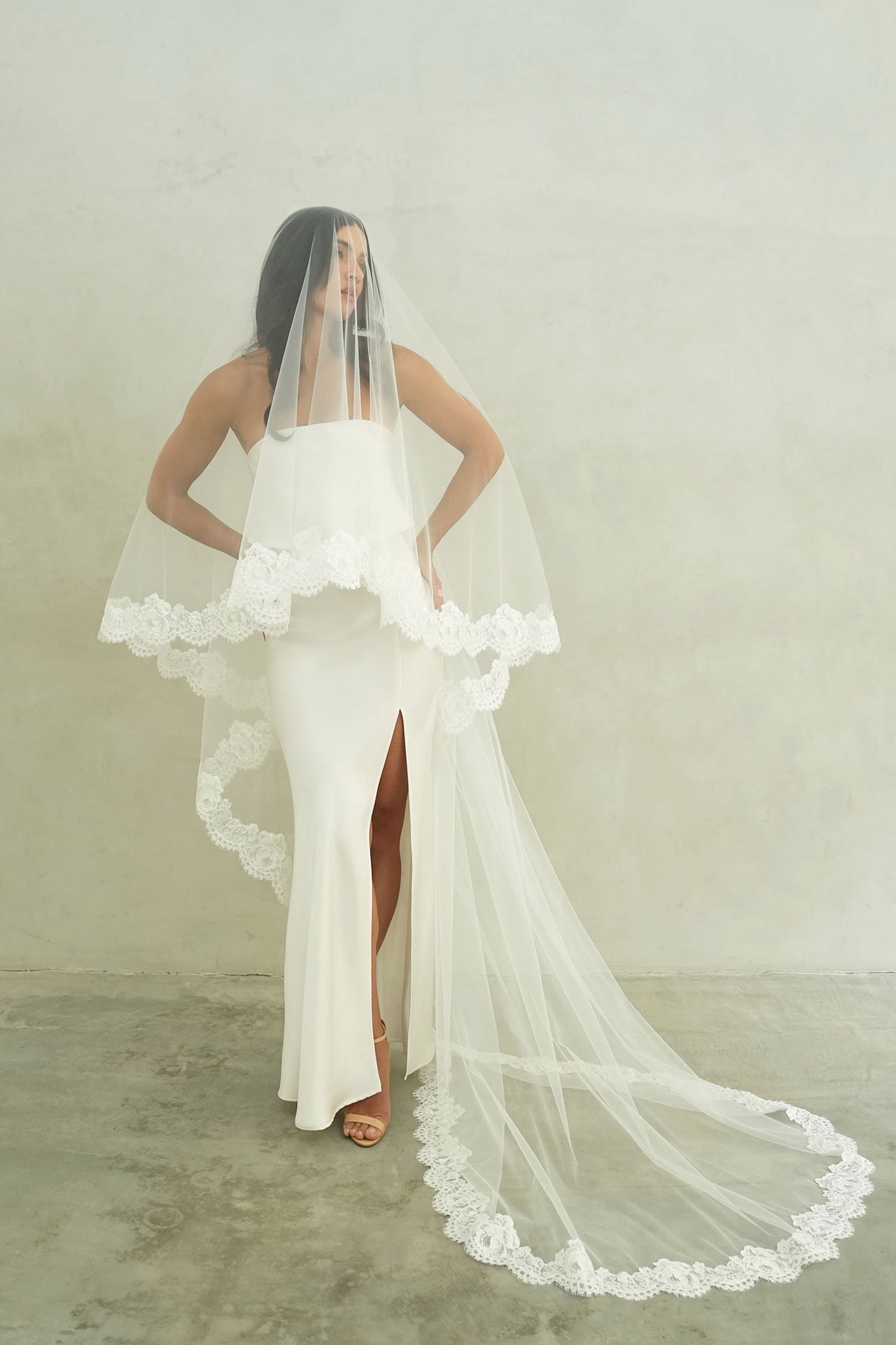 model wears mantilla veil, drop lace trim wedding veil