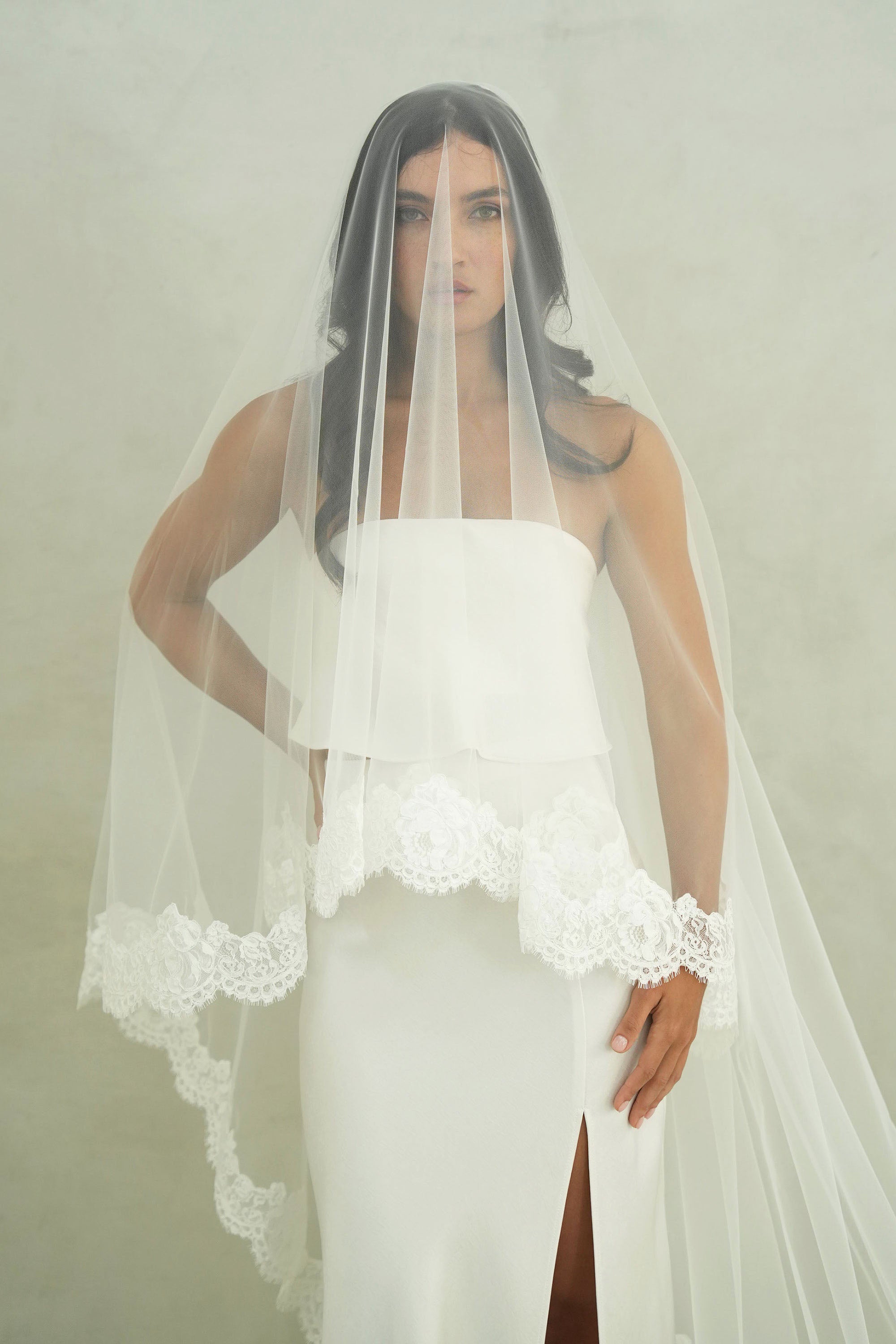 model wears mantilla veil, drop lace trim wedding veil