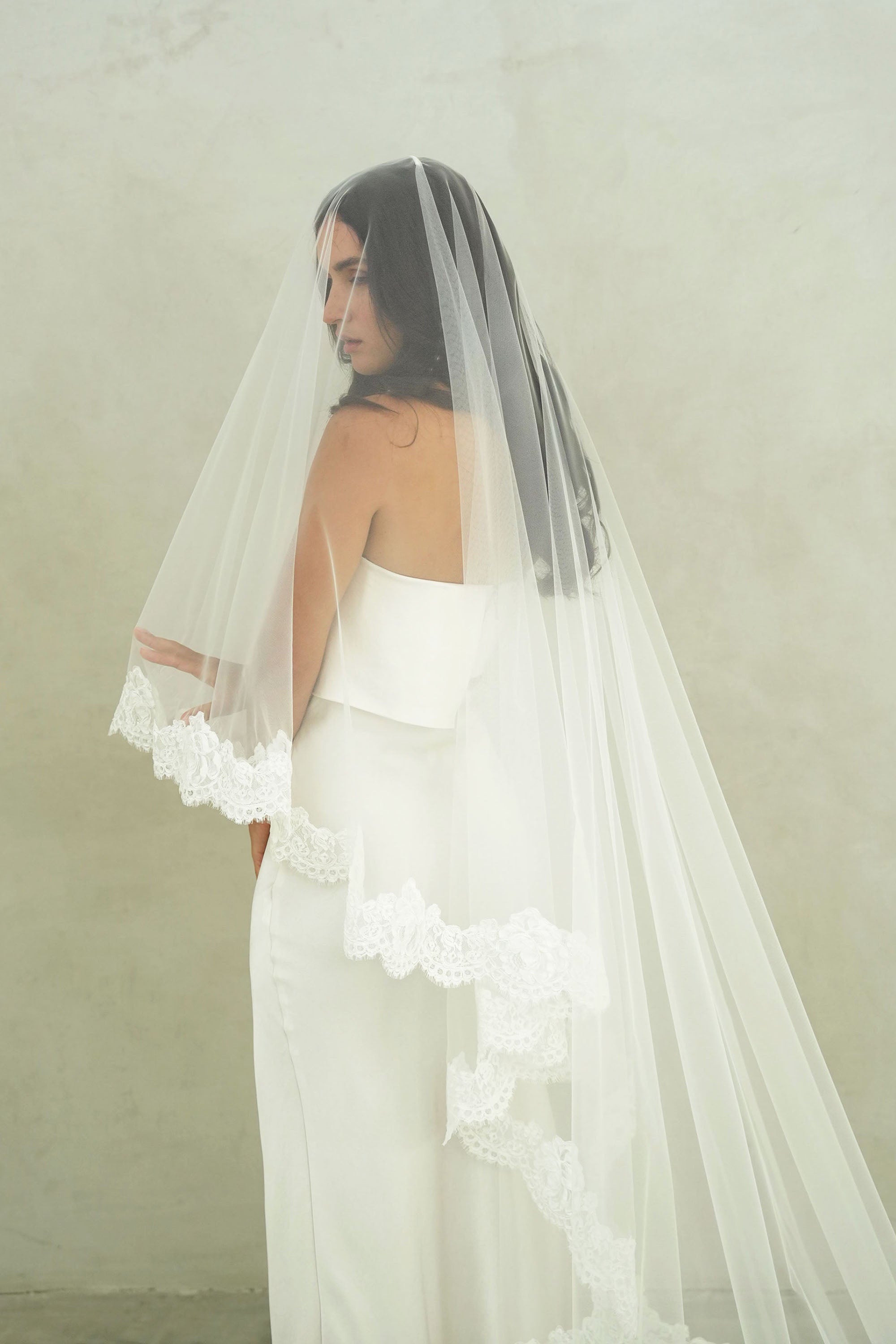 model wears mantilla veil, drop lace trim wedding veil