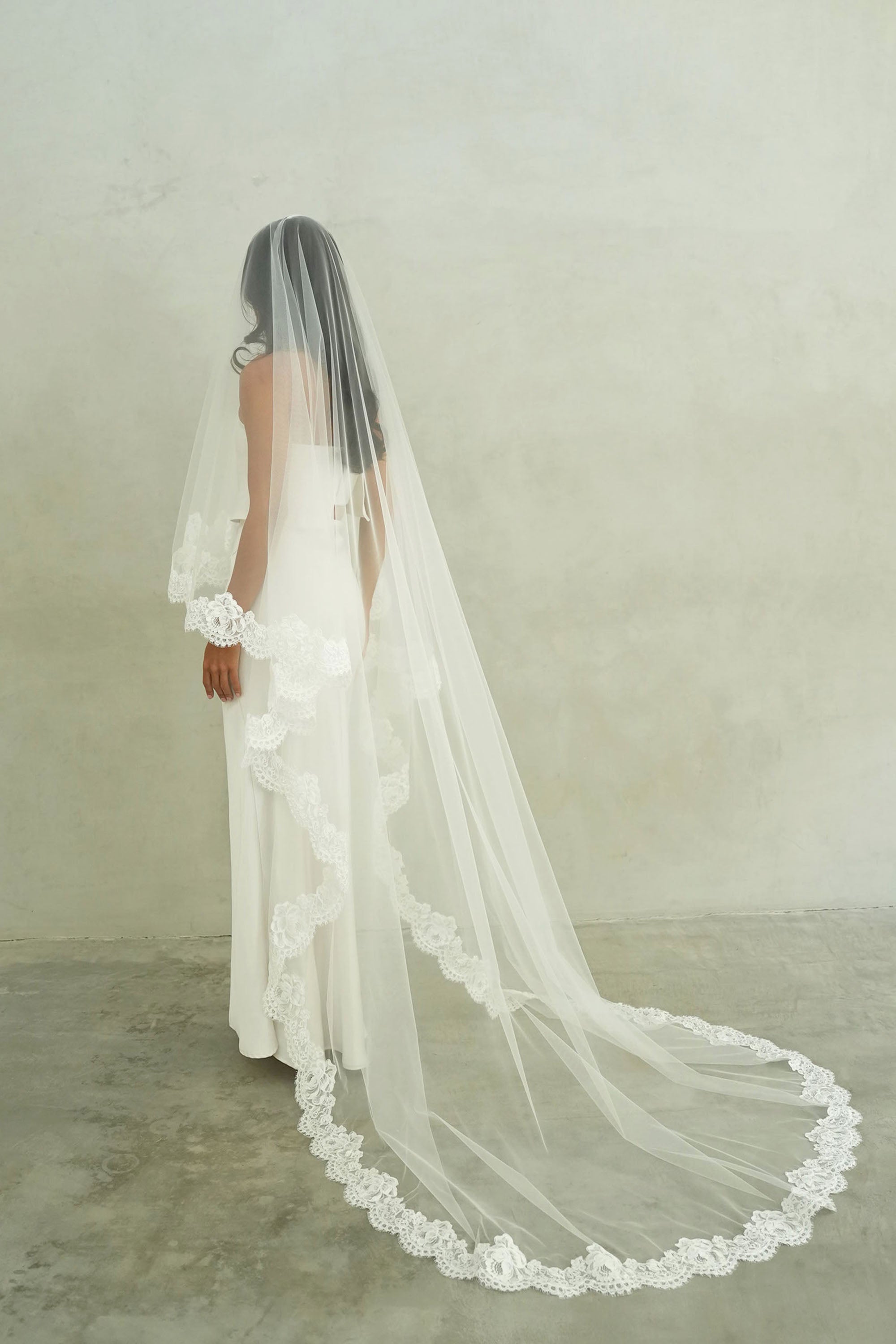 model wears mantilla veil, drop lace trim wedding veil