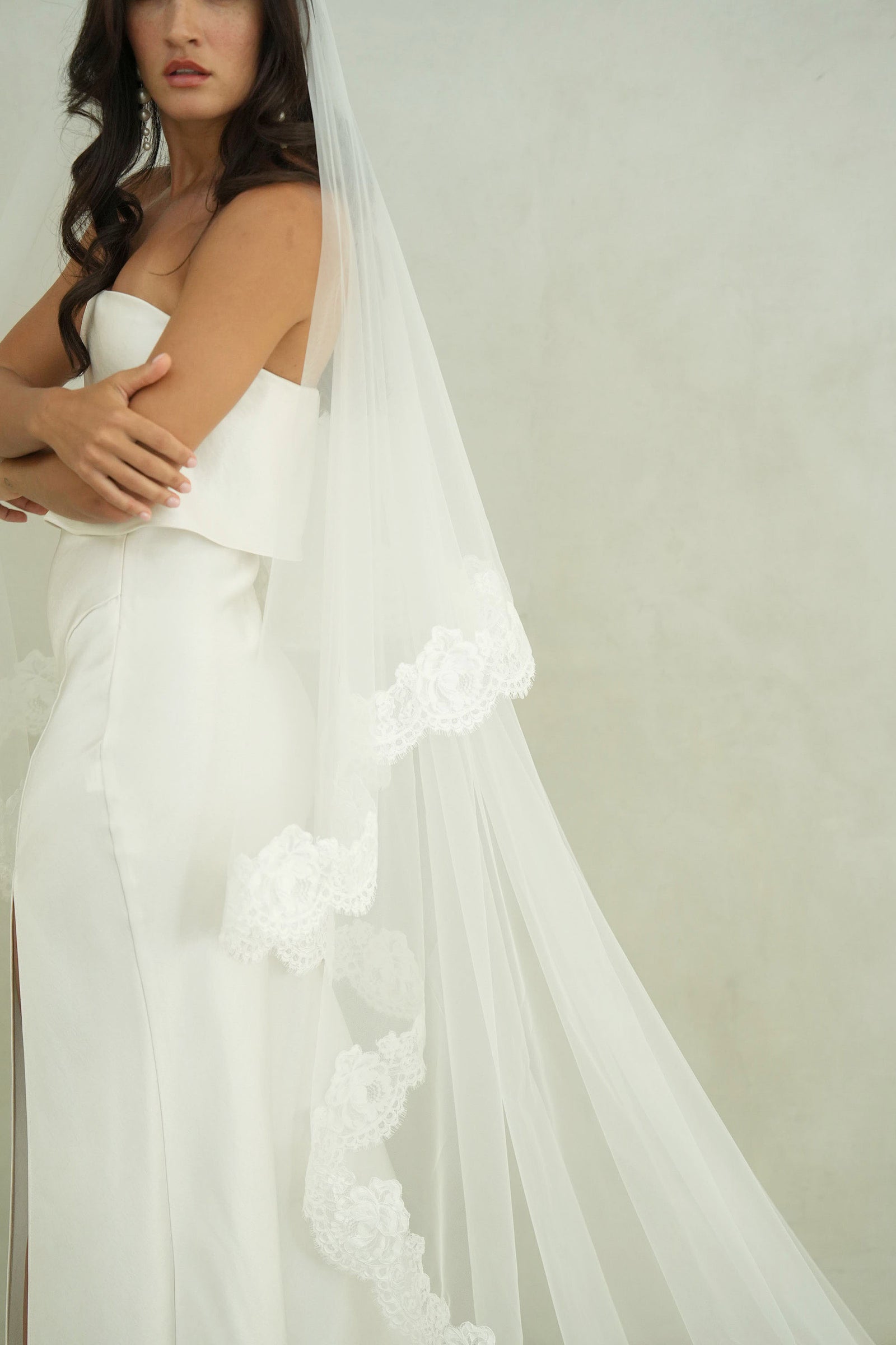 model wears mantilla veil, drop lace trim wedding veil