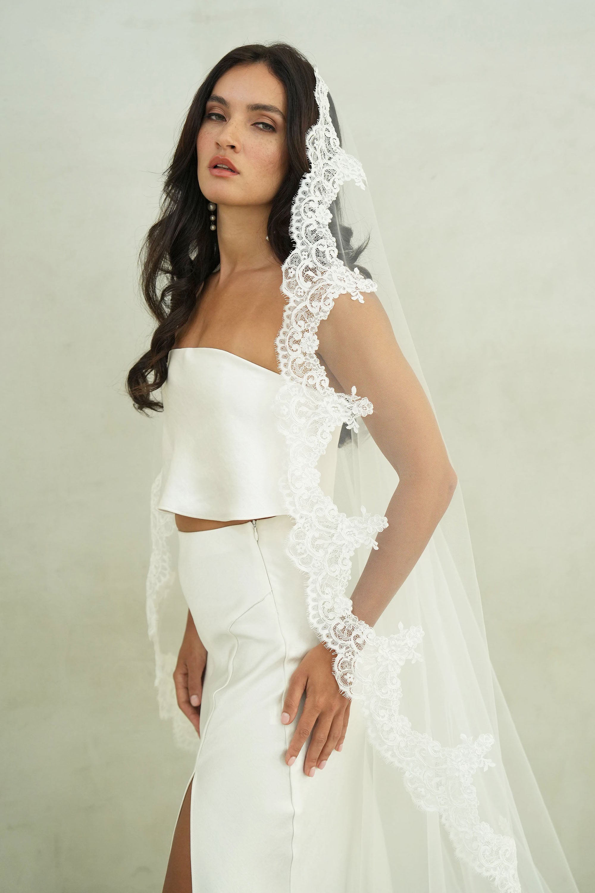 model wears mantilla veil, one-tier lace trim wedding veil