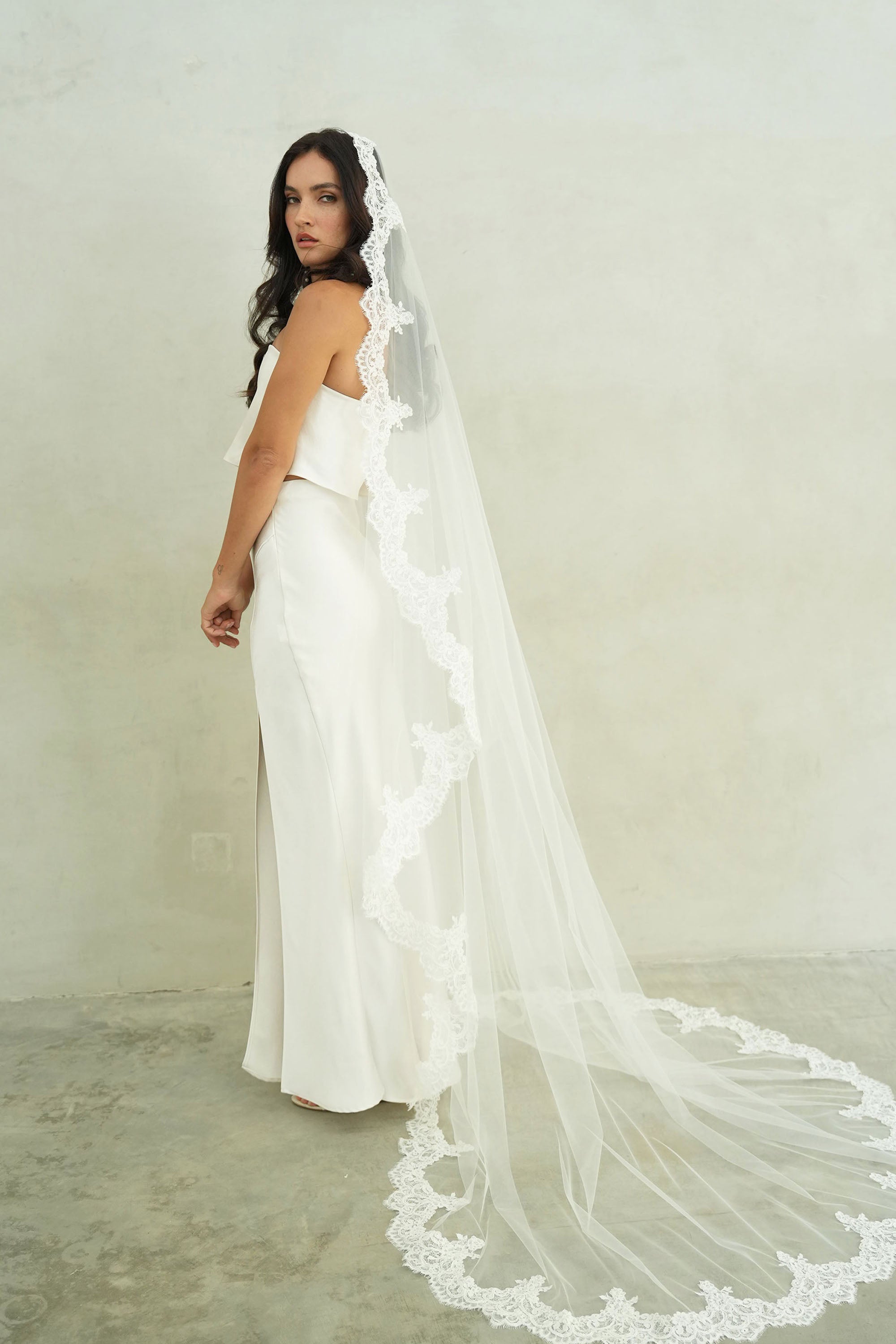 model wears mantilla veil, one-tier lace trim wedding veil