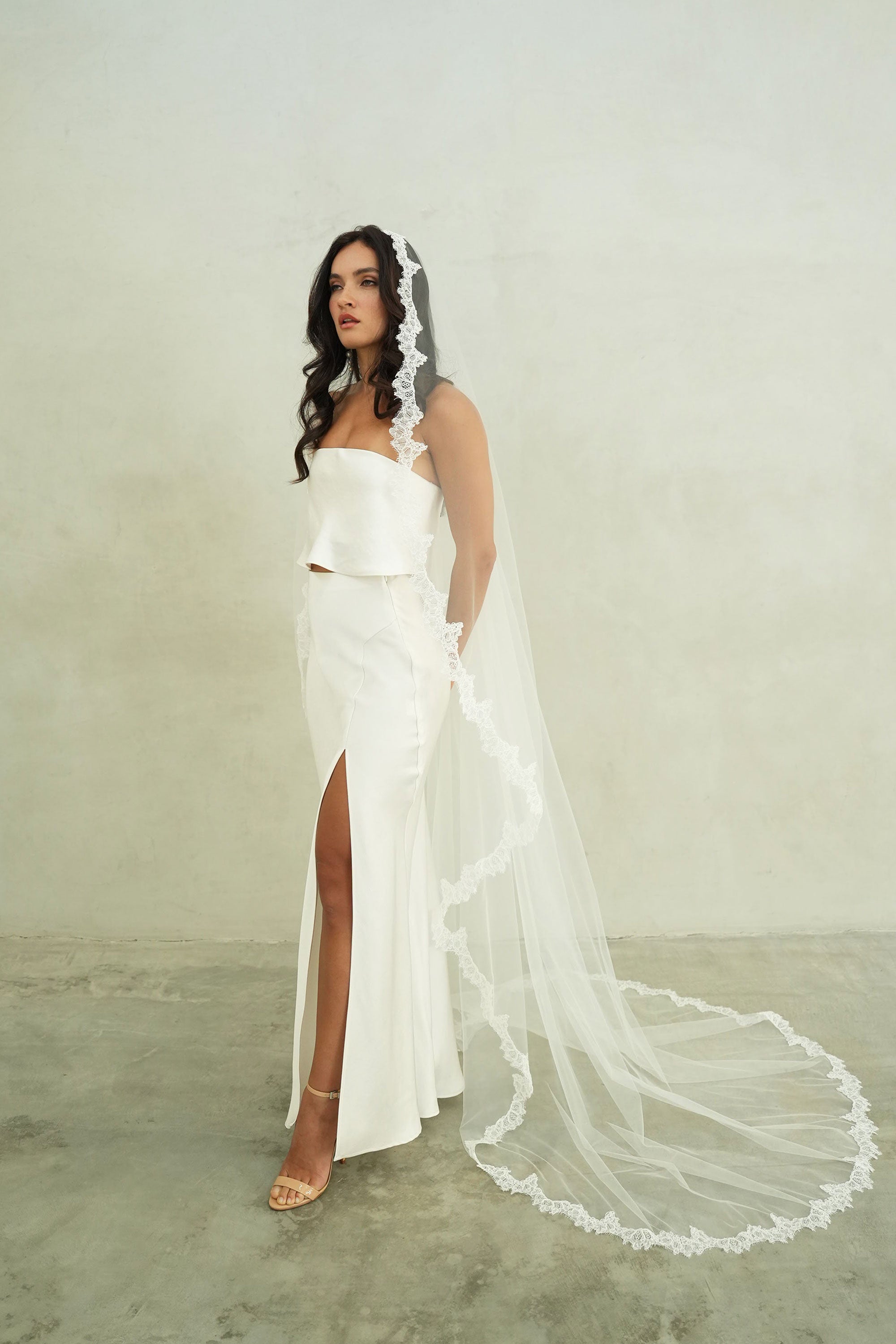 model wears mantilla veil, single-tier wedding veil with lace trim