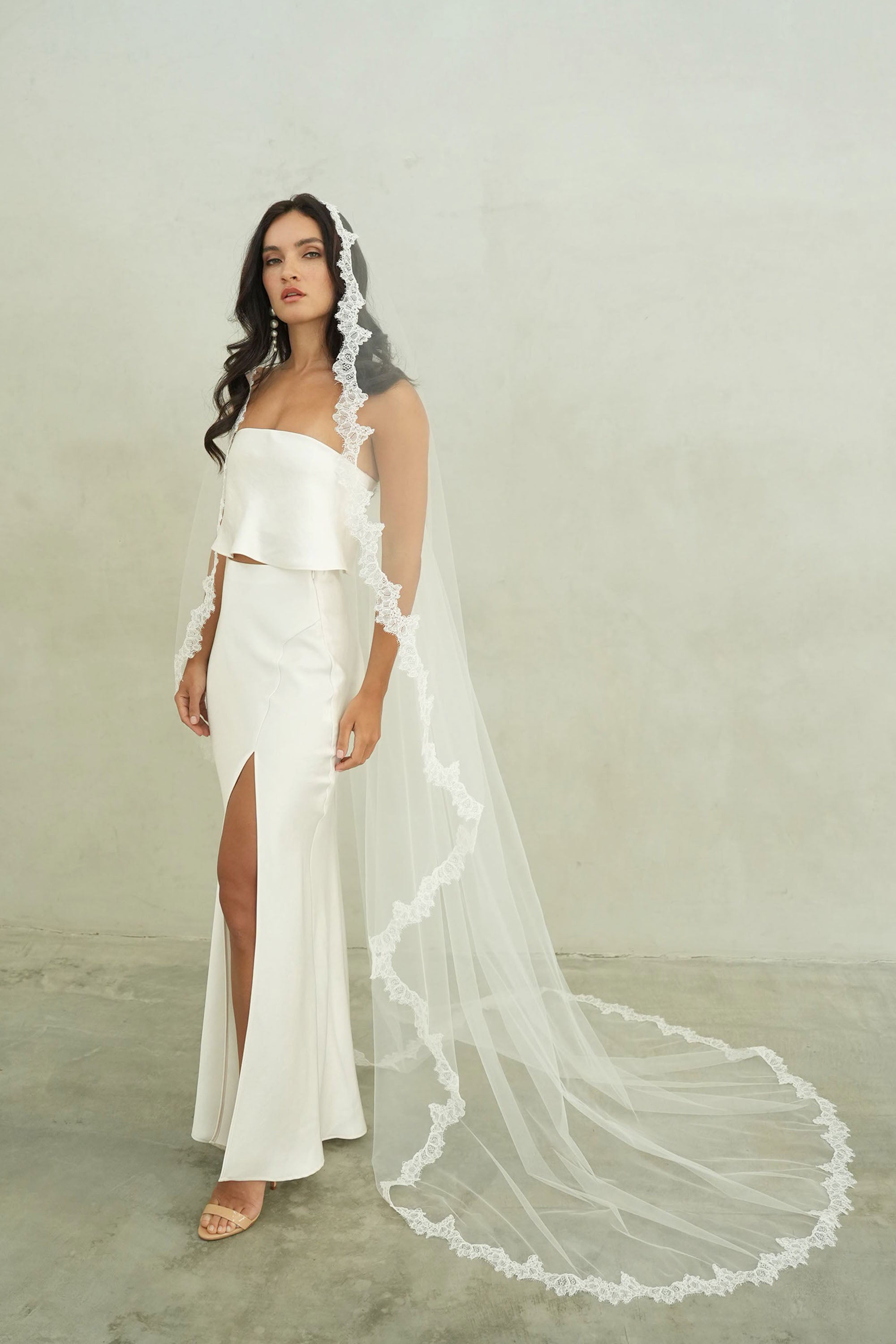 model wears mantilla veil, single-tier wedding veil with lace trim