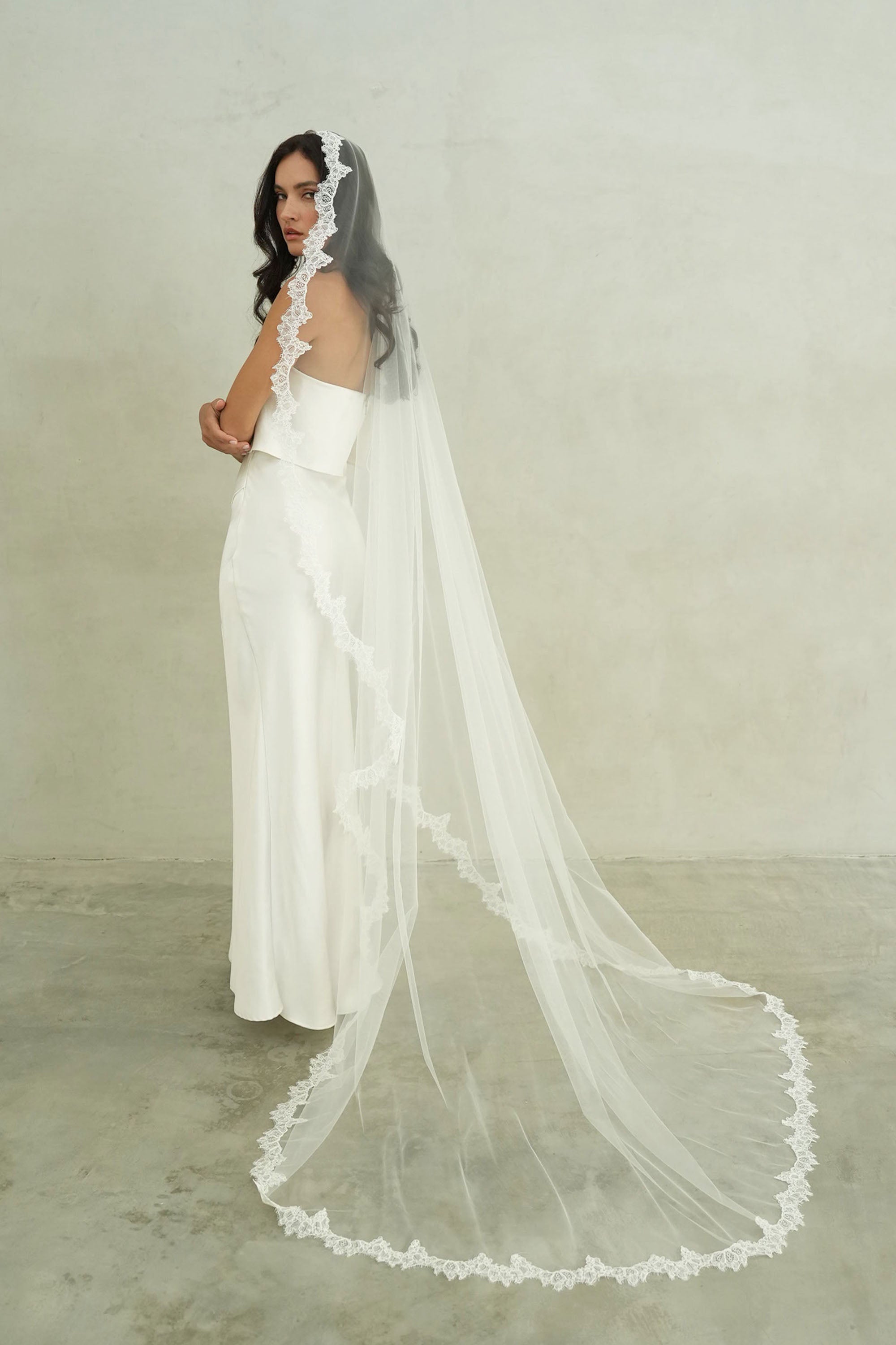model wears mantilla veil, single-tier wedding veil with lace trim