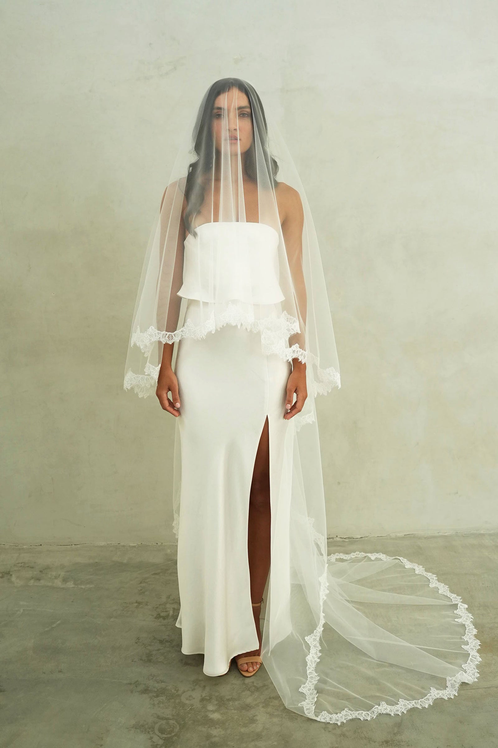 model wears mantilla veil, drop veil with lace trim