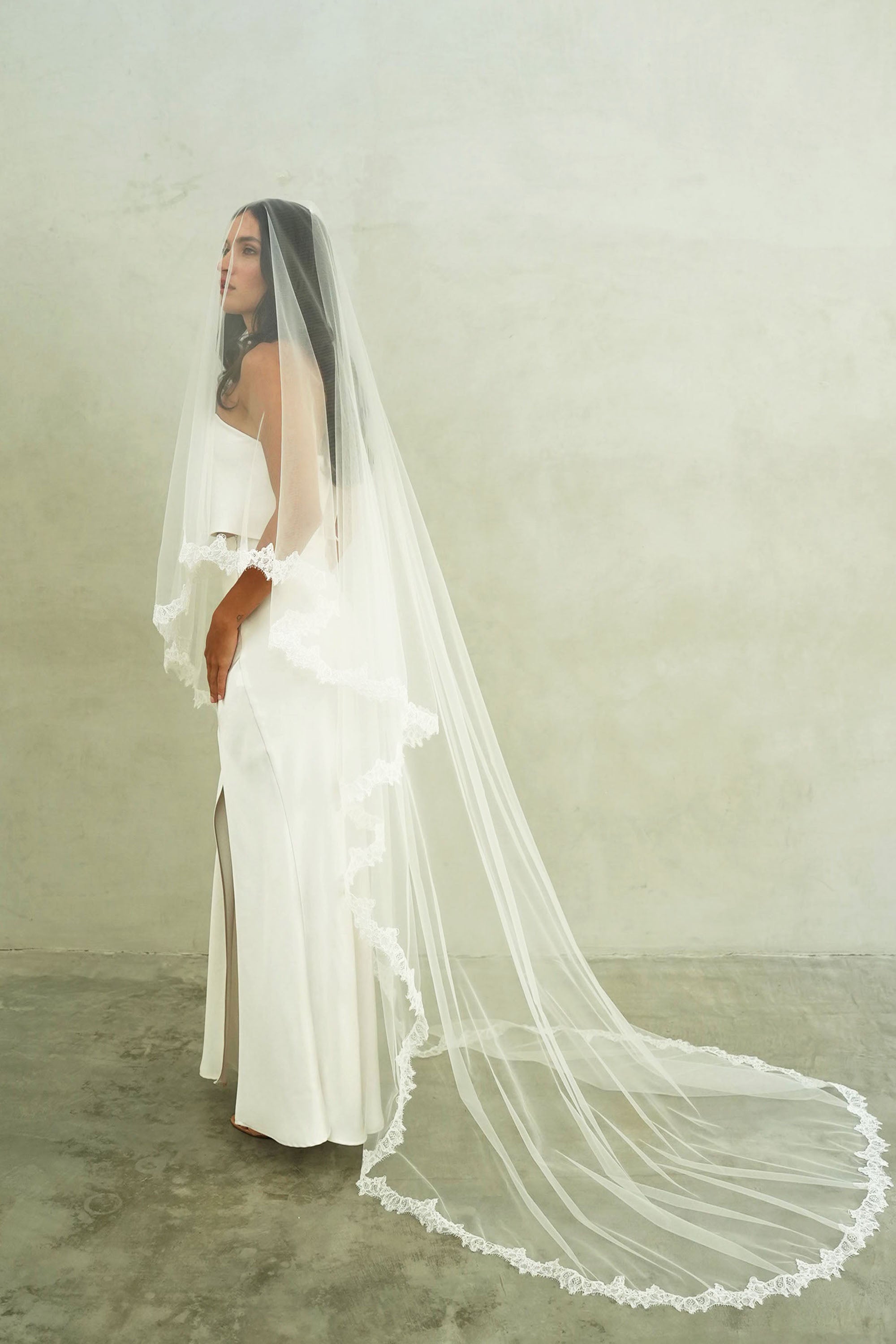 model wears mantilla veil, drop veil with lace trim
