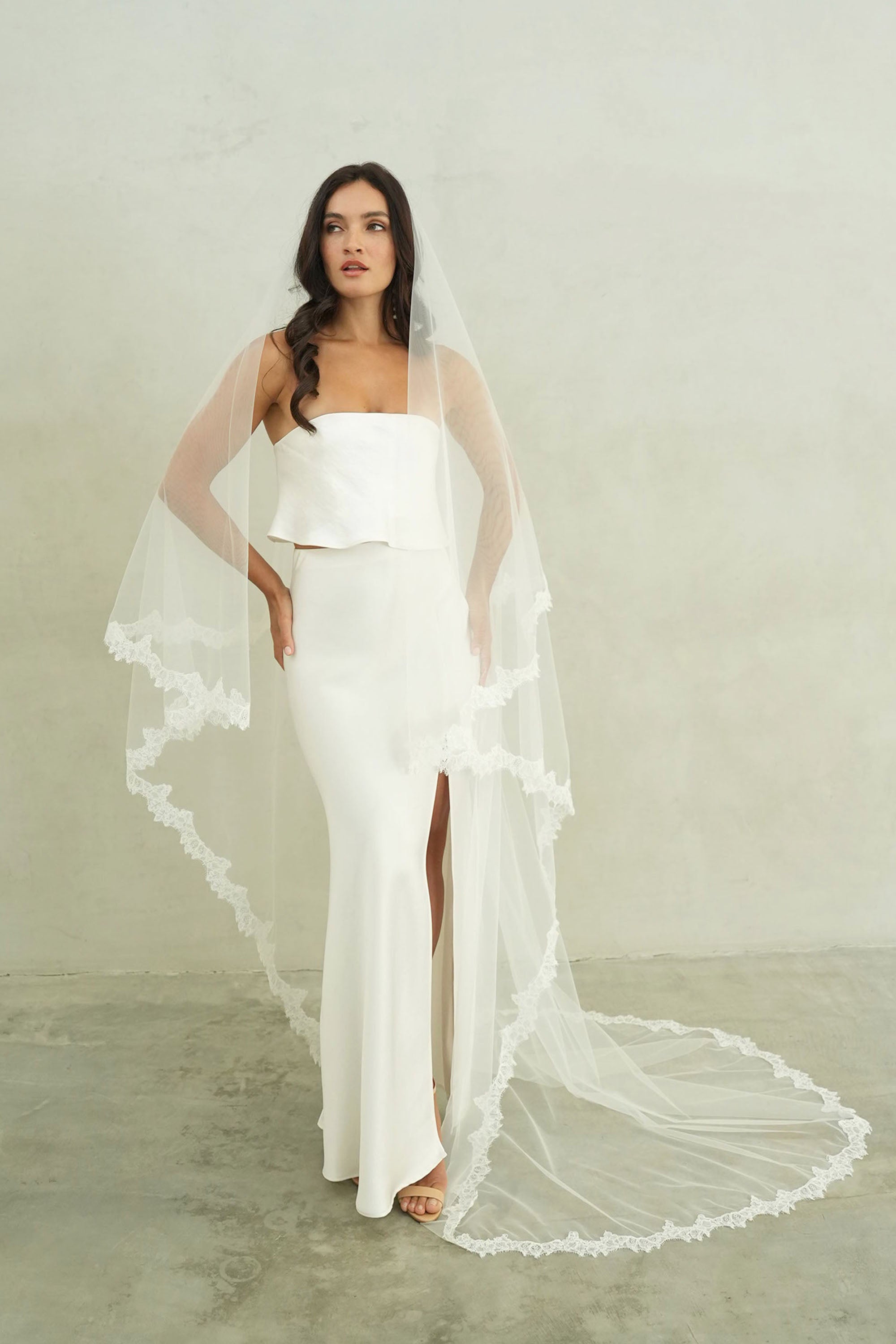 model wears mantilla veil, drop veil with lace trim