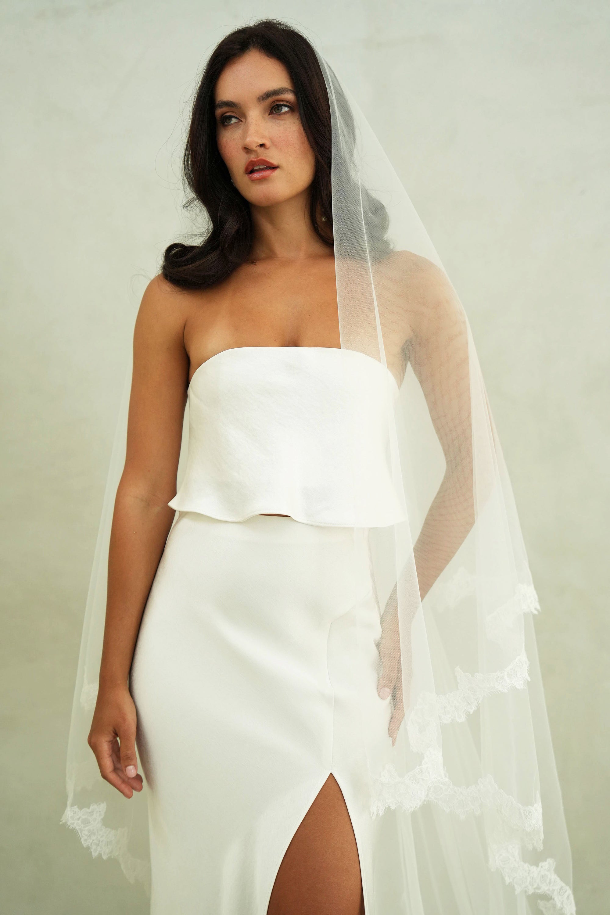 model wears mantilla veil, drop veil with lace trim