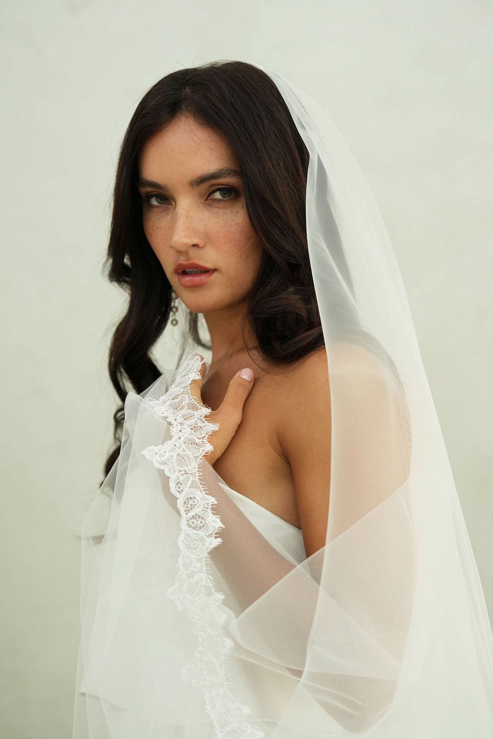model wears mantilla veil, drop veil with lace trim