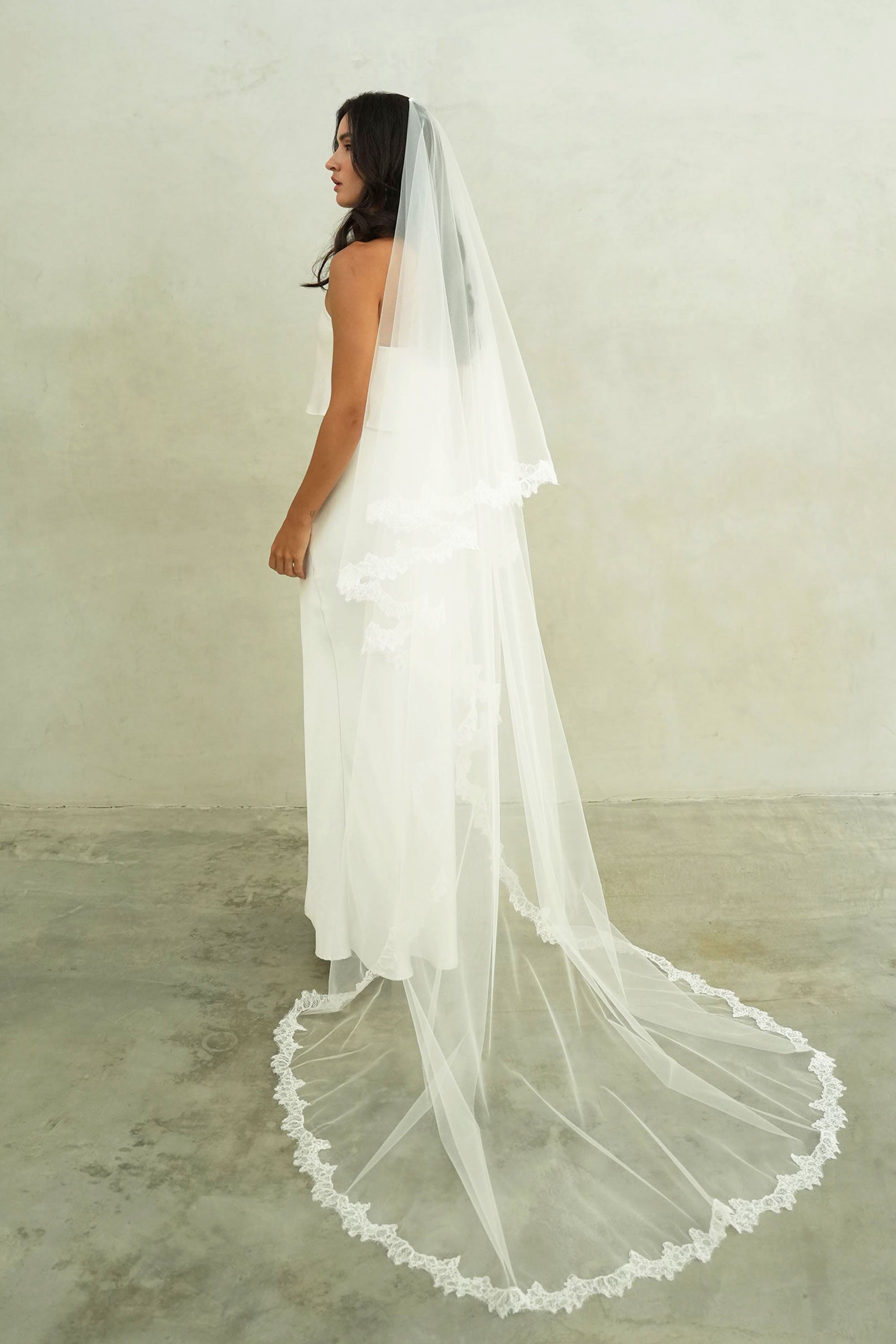 model wears mantilla veil, drop veil with lace trim