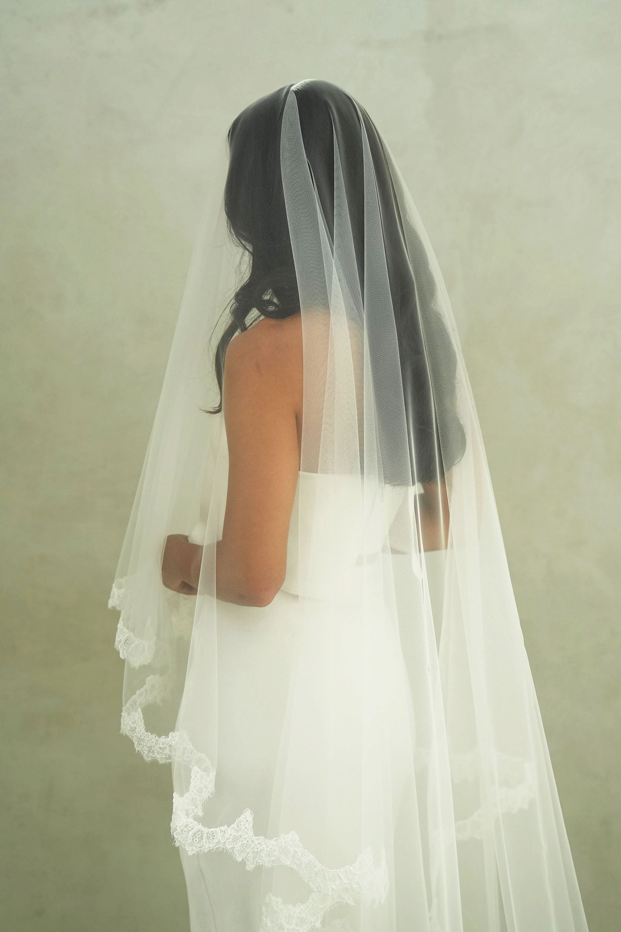 model wears mantilla veil, drop veil with lace trim