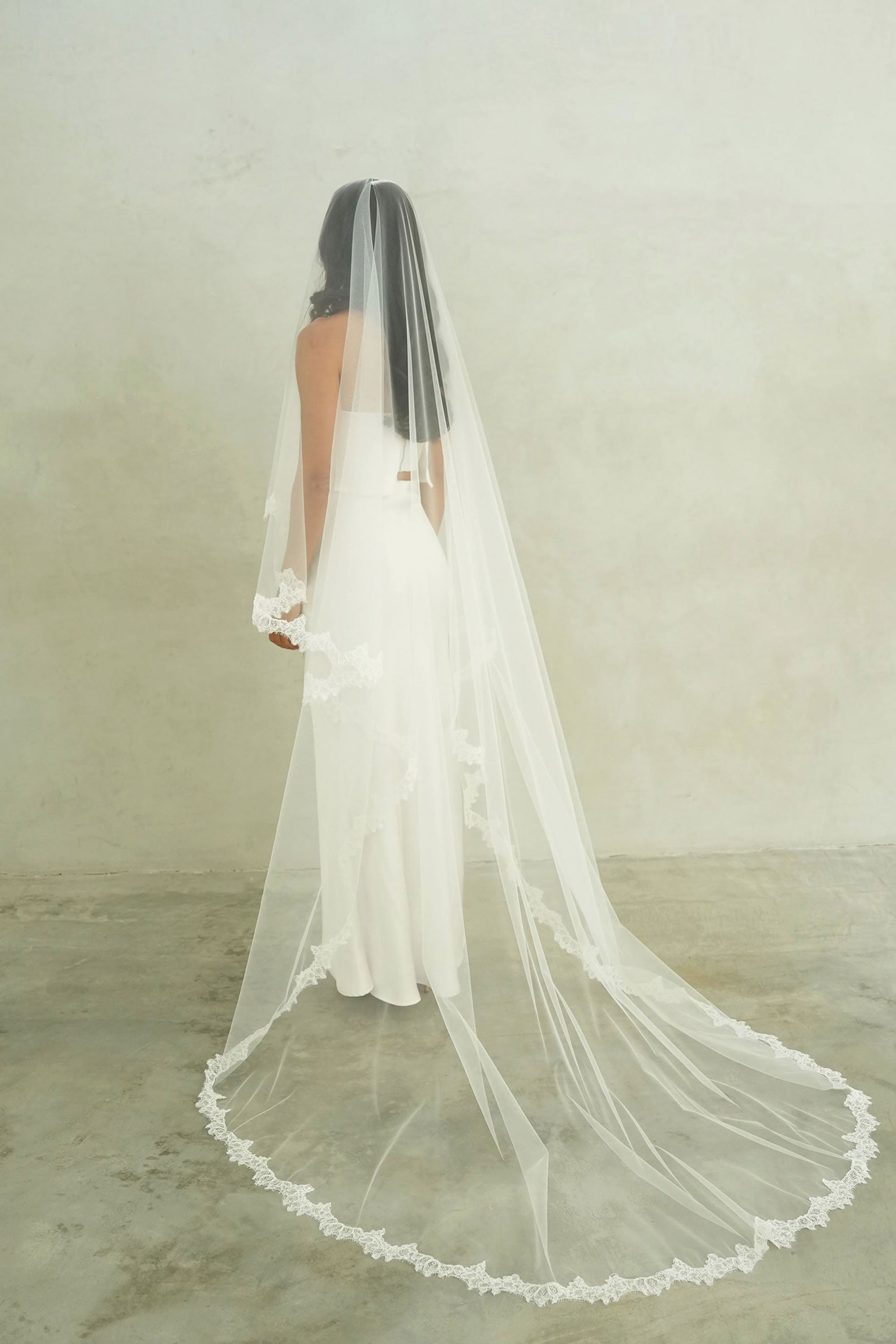 model wears mantilla veil, drop veil with lace trim