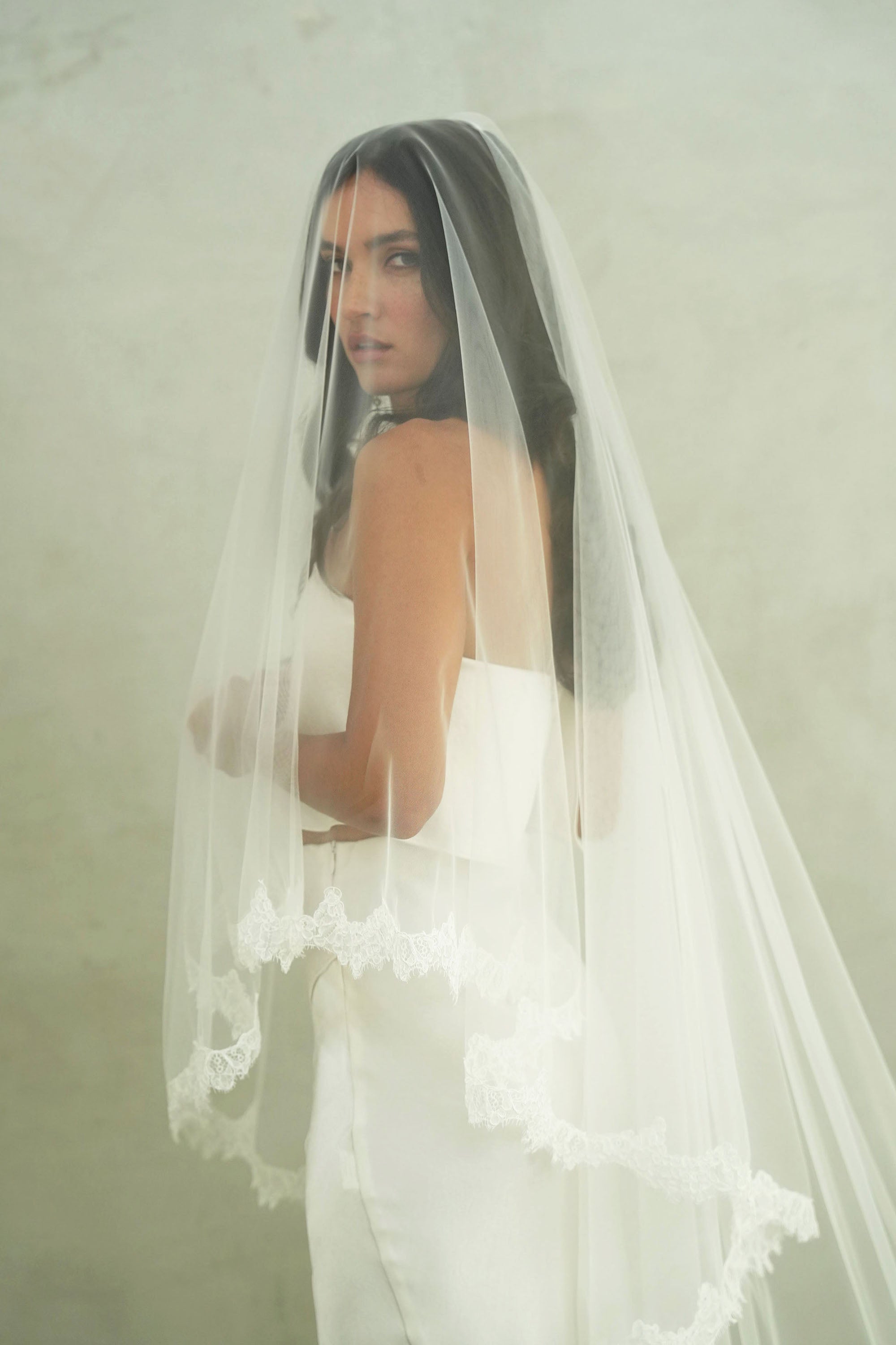 model wears mantilla veil, drop veil with lace trim