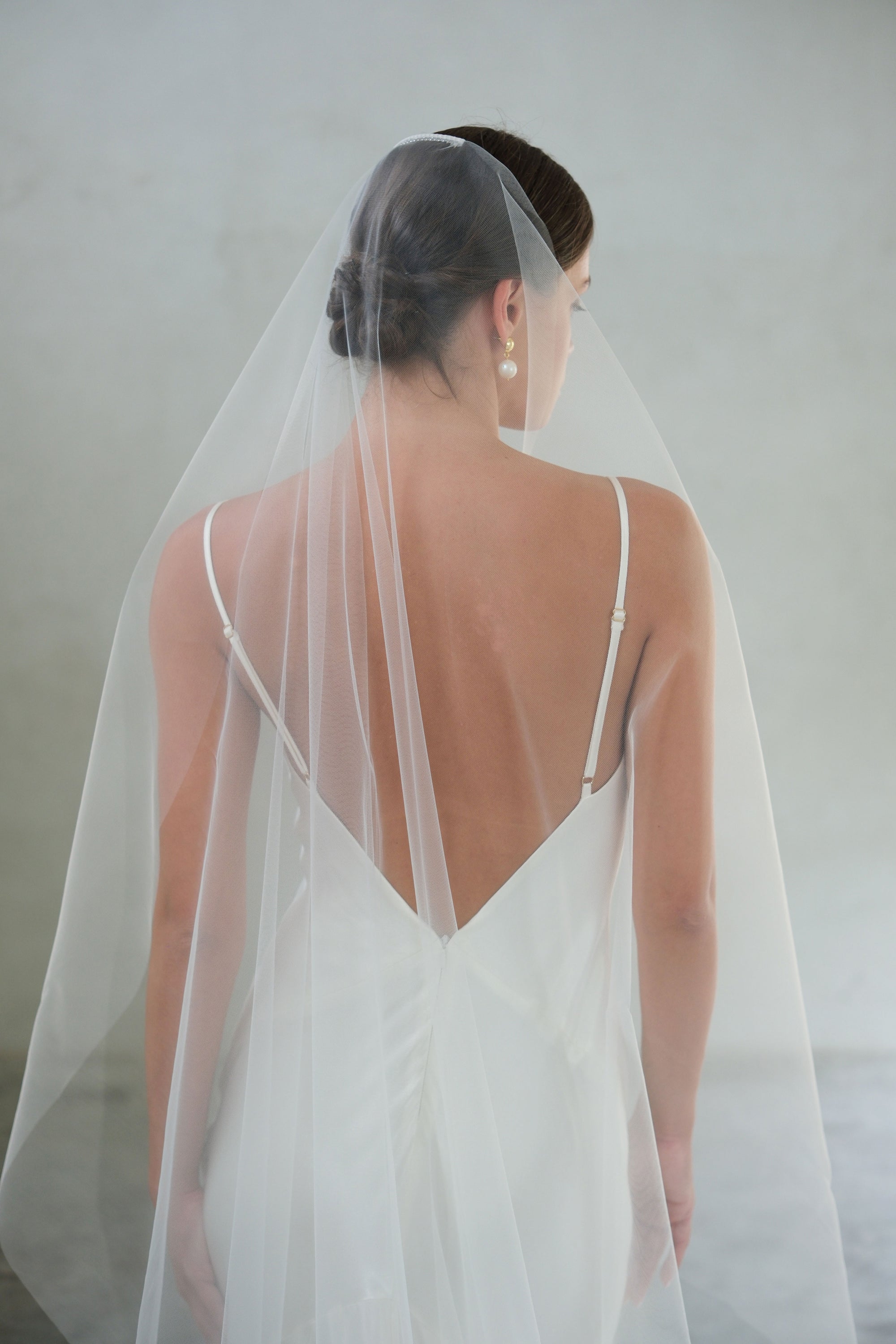 Half length back view of minimalist tulle bridal veil