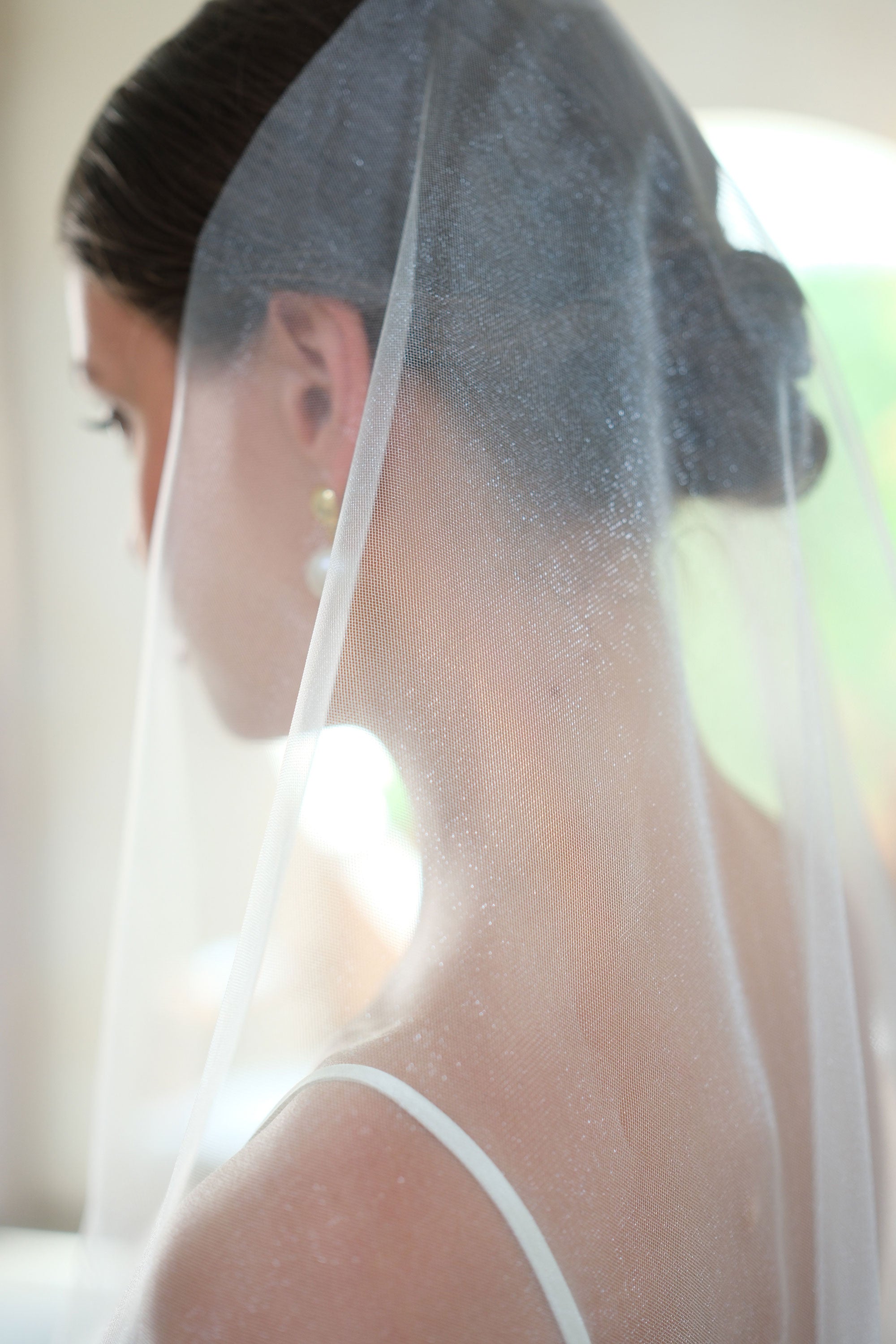 Close-up of shimmer tulle bridal veil fabric, worn mantilla-style