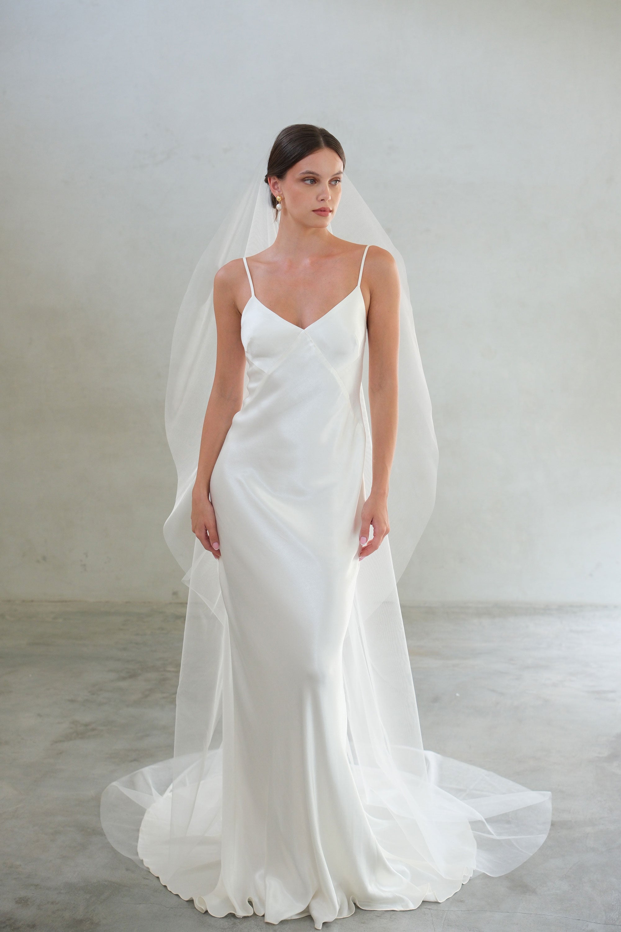 Full length, front-facing view of bride wearing long, plain, matilla-style bridal veil. Shimmer tulle.