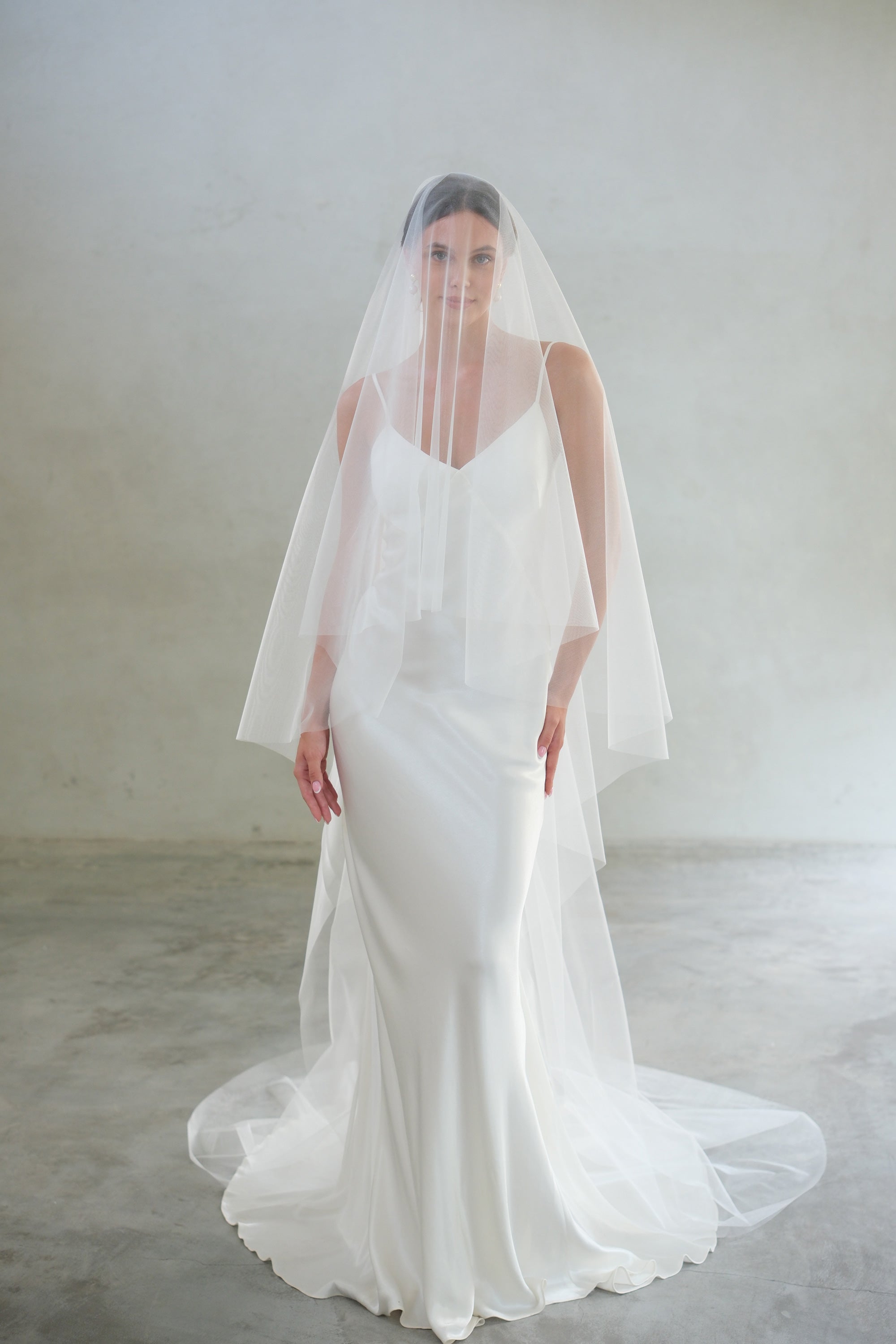 Full length, front-facing shot of bride wearing two-tier plain, shimmer tulle veil - blusher down